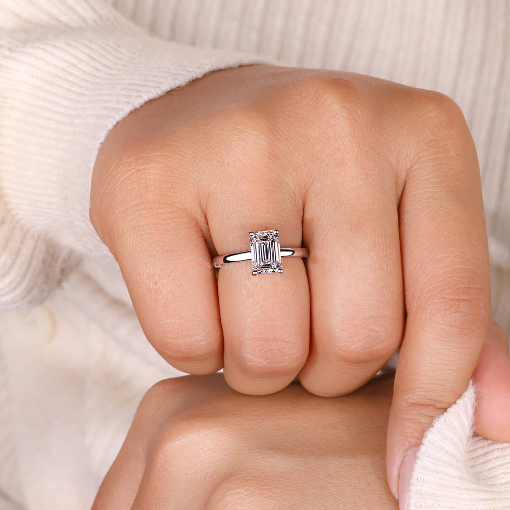Solitaire engagement ring crafted with an emerald cut diamond and IGI certified quality.
