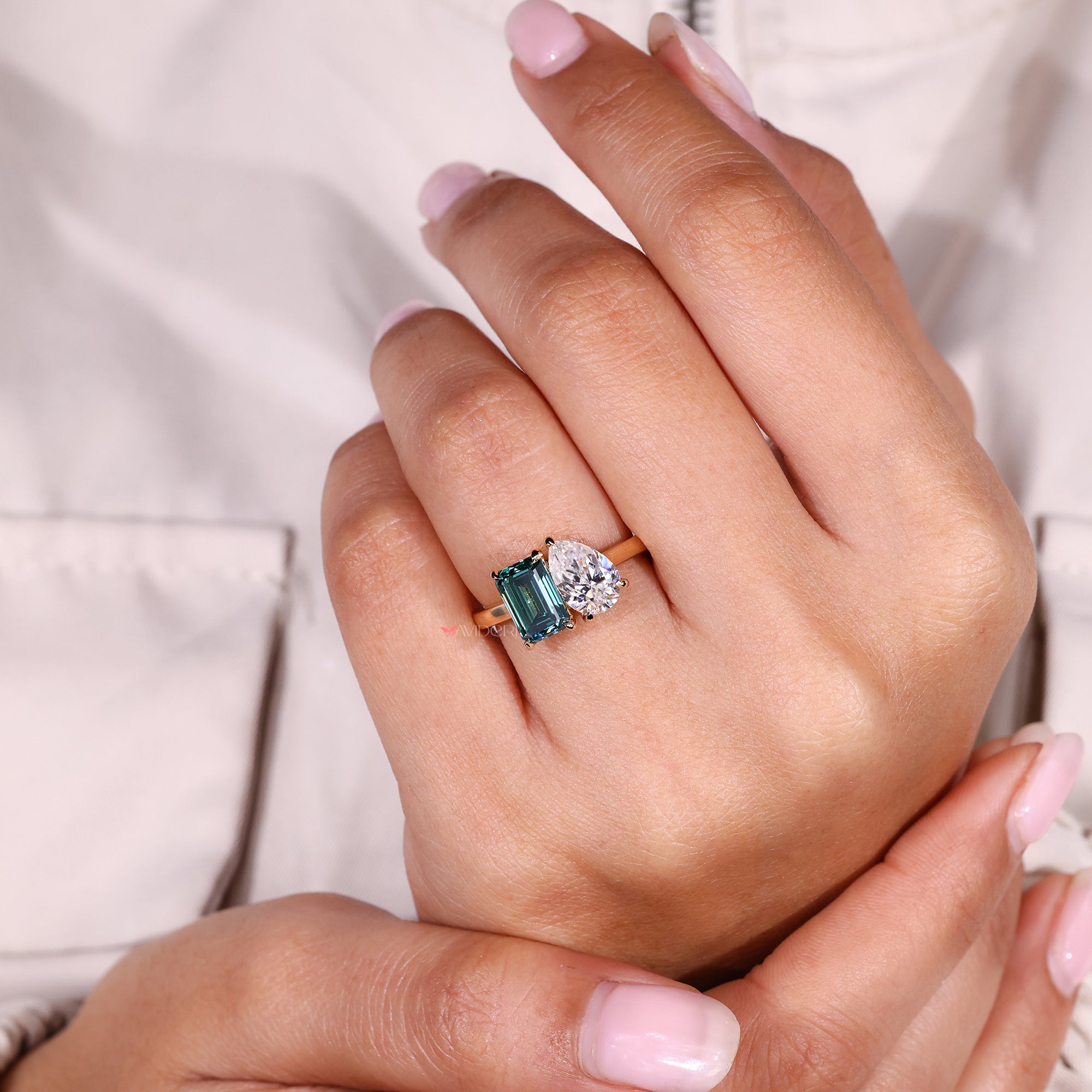 Pear cut engagement ring with claw prong setting in yellow gold.