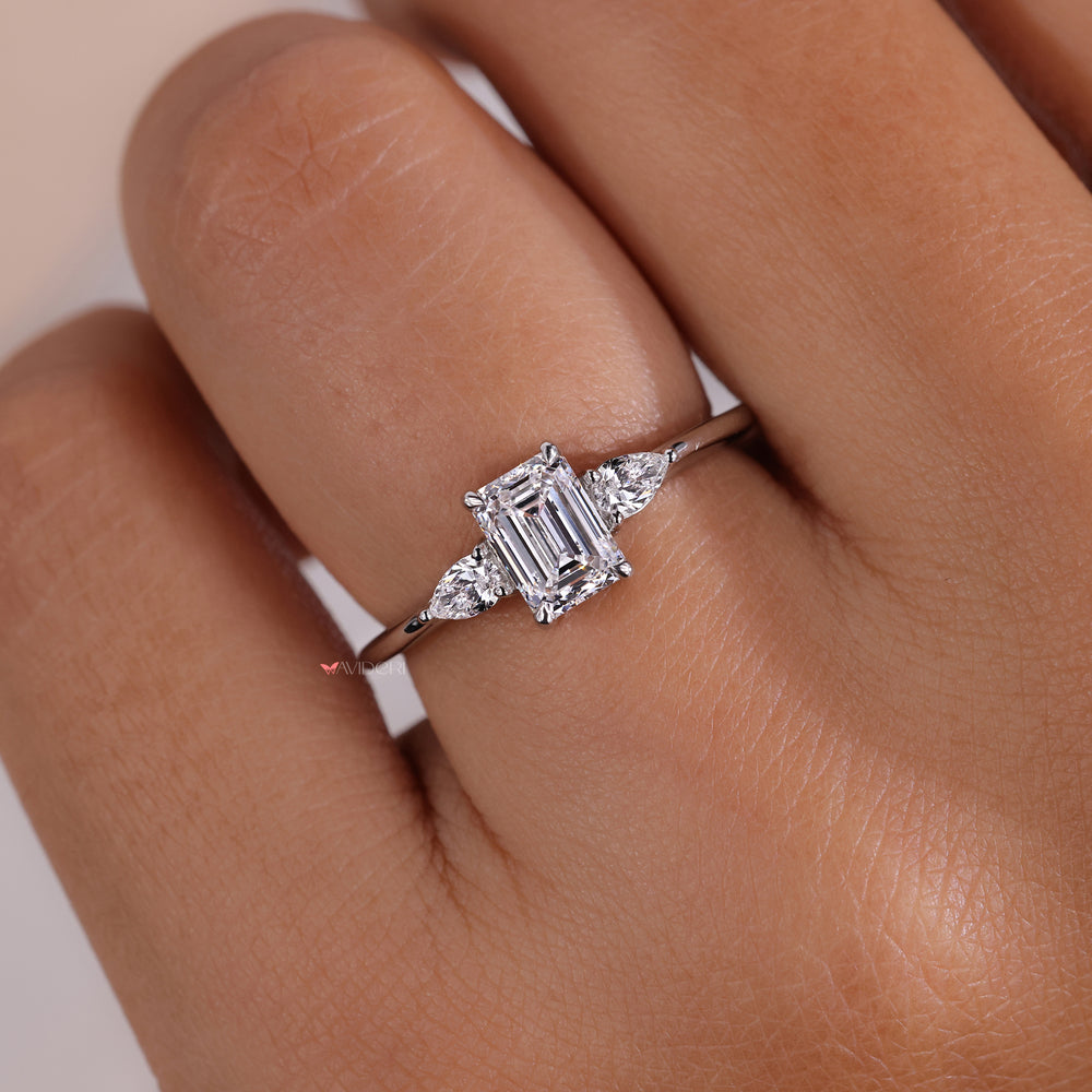 Engagement ring with pear side stones designed in a claw setting ring, offering durability and exceptional sparkle.
