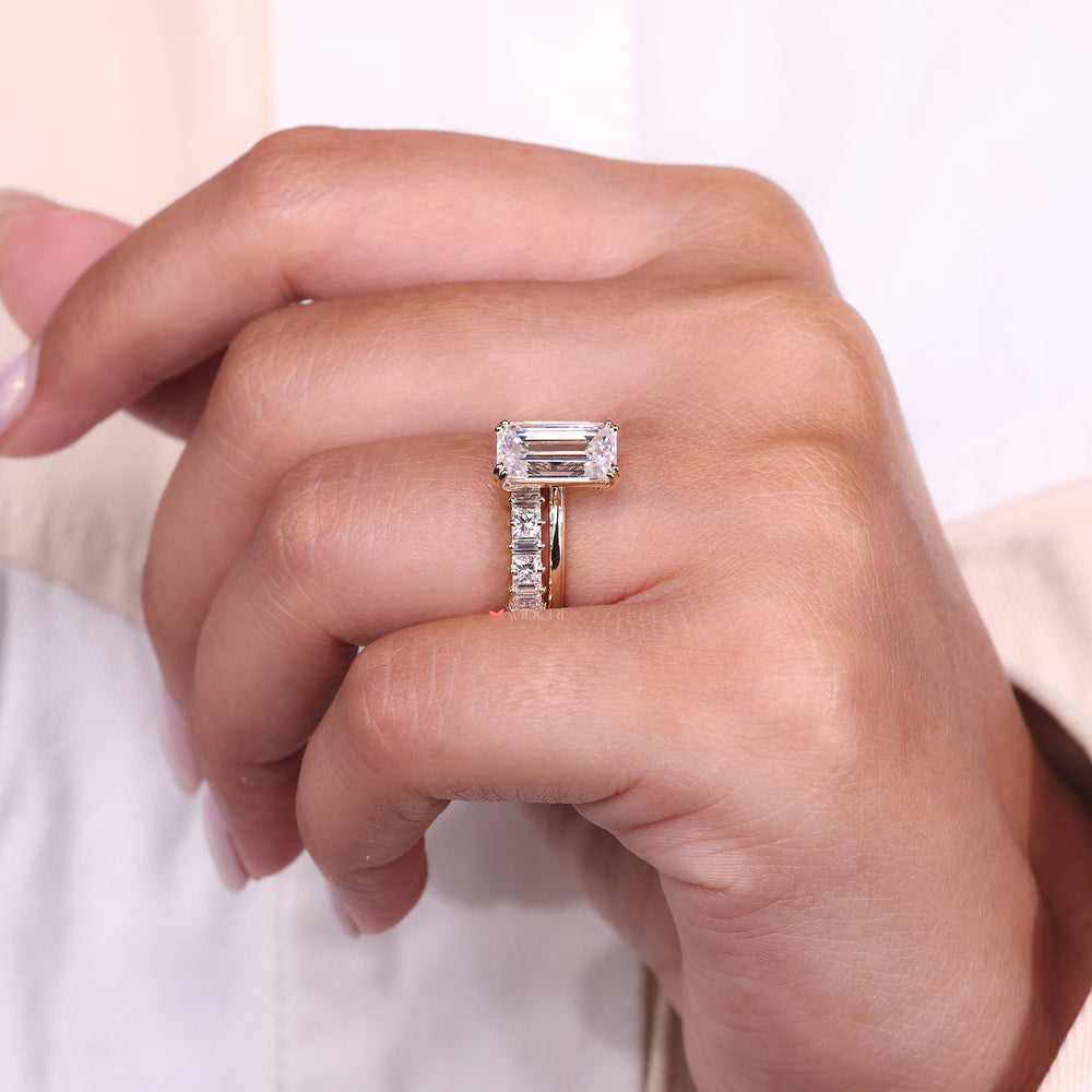 Moissanite bridal set including an emerald cut solitaire and geometric diamond band.