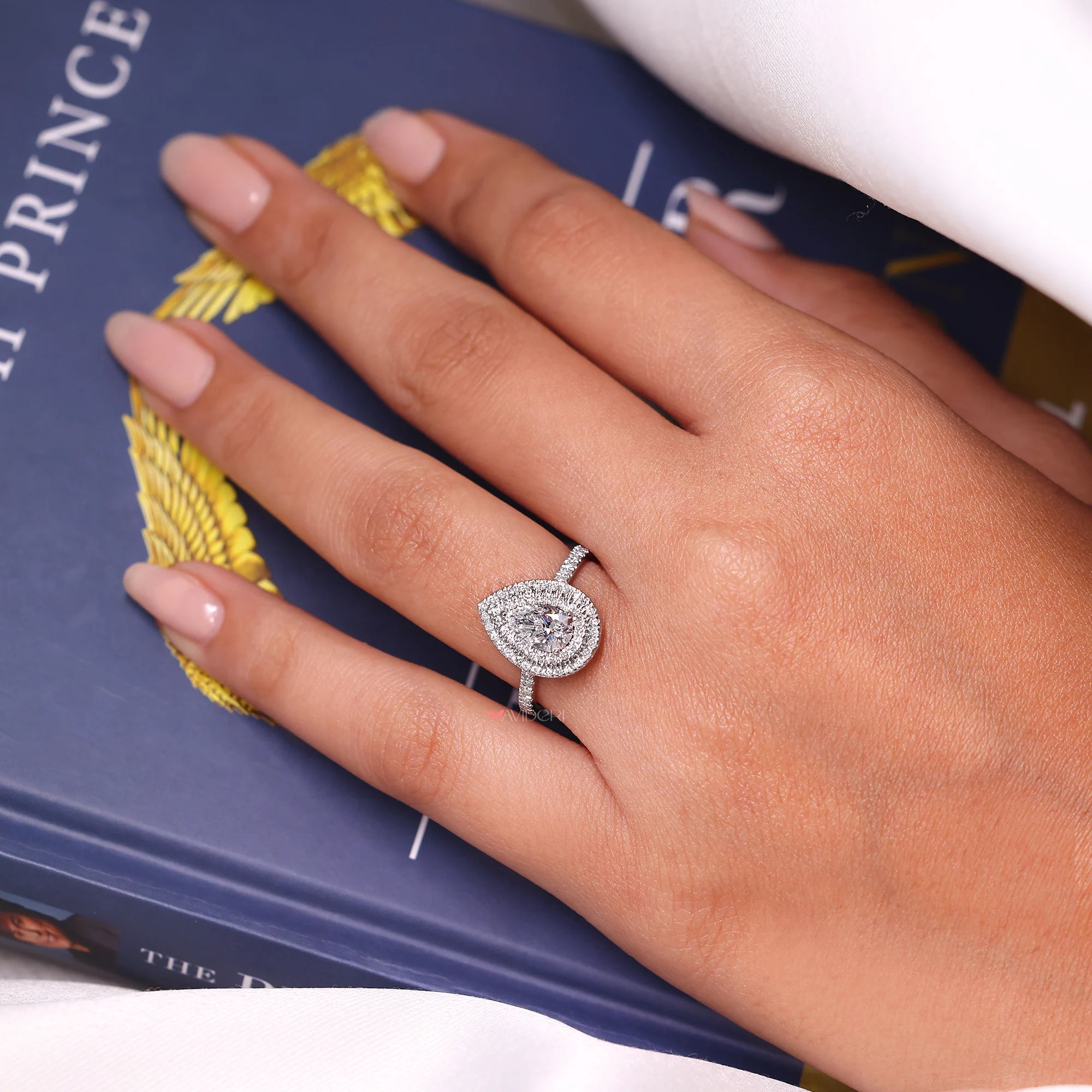 Stunning double halo pear engagement ring with intricate design.