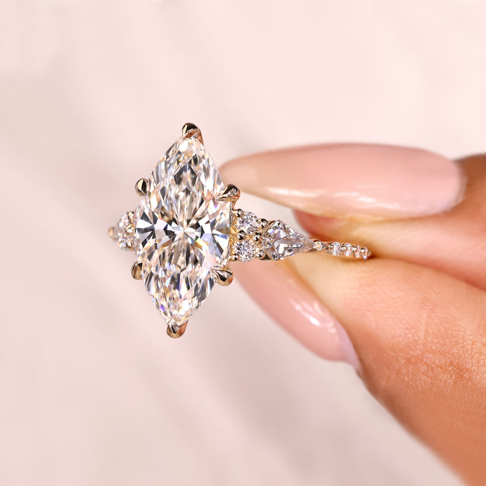 Handmade marquise engagement ring with tapered pave shank.
