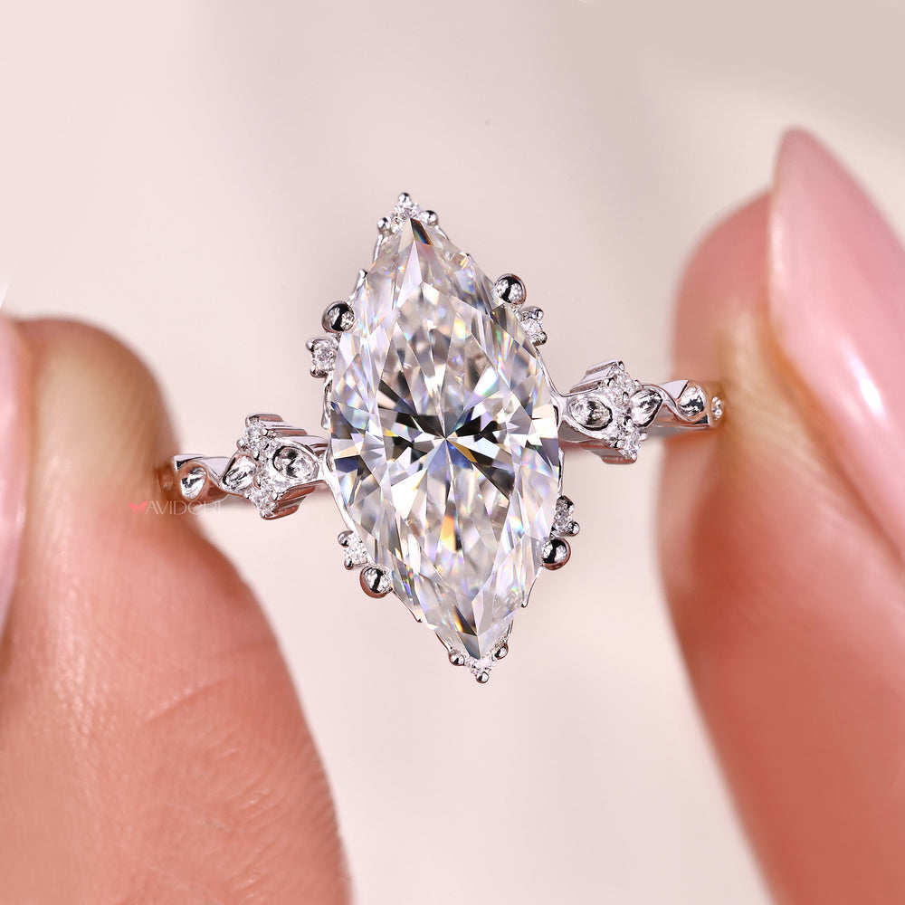 Avideri ring designed with a marquise moissanite and side stones.