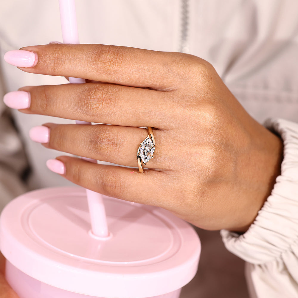 Marquise engagement ring with six claw prongs and bypass
