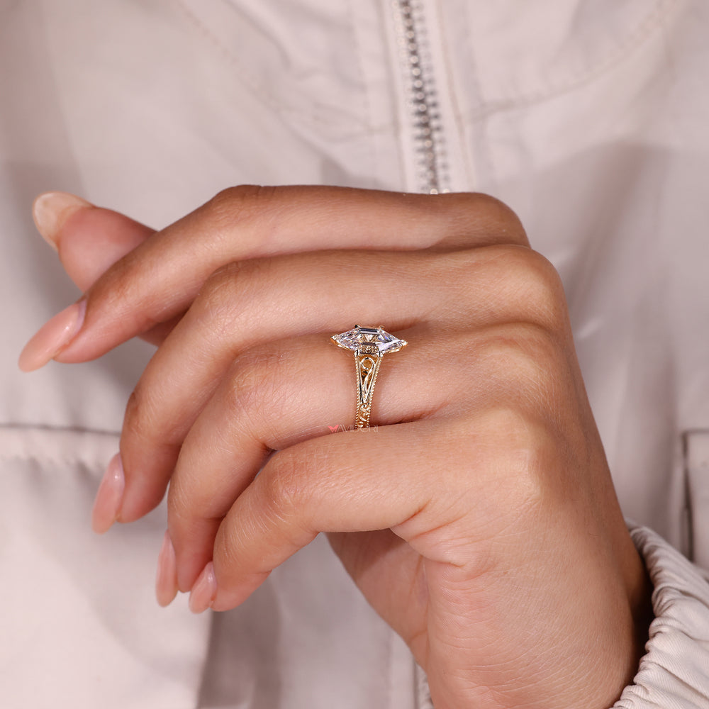 Hexagon step cut diamond ring with engraved shank.
