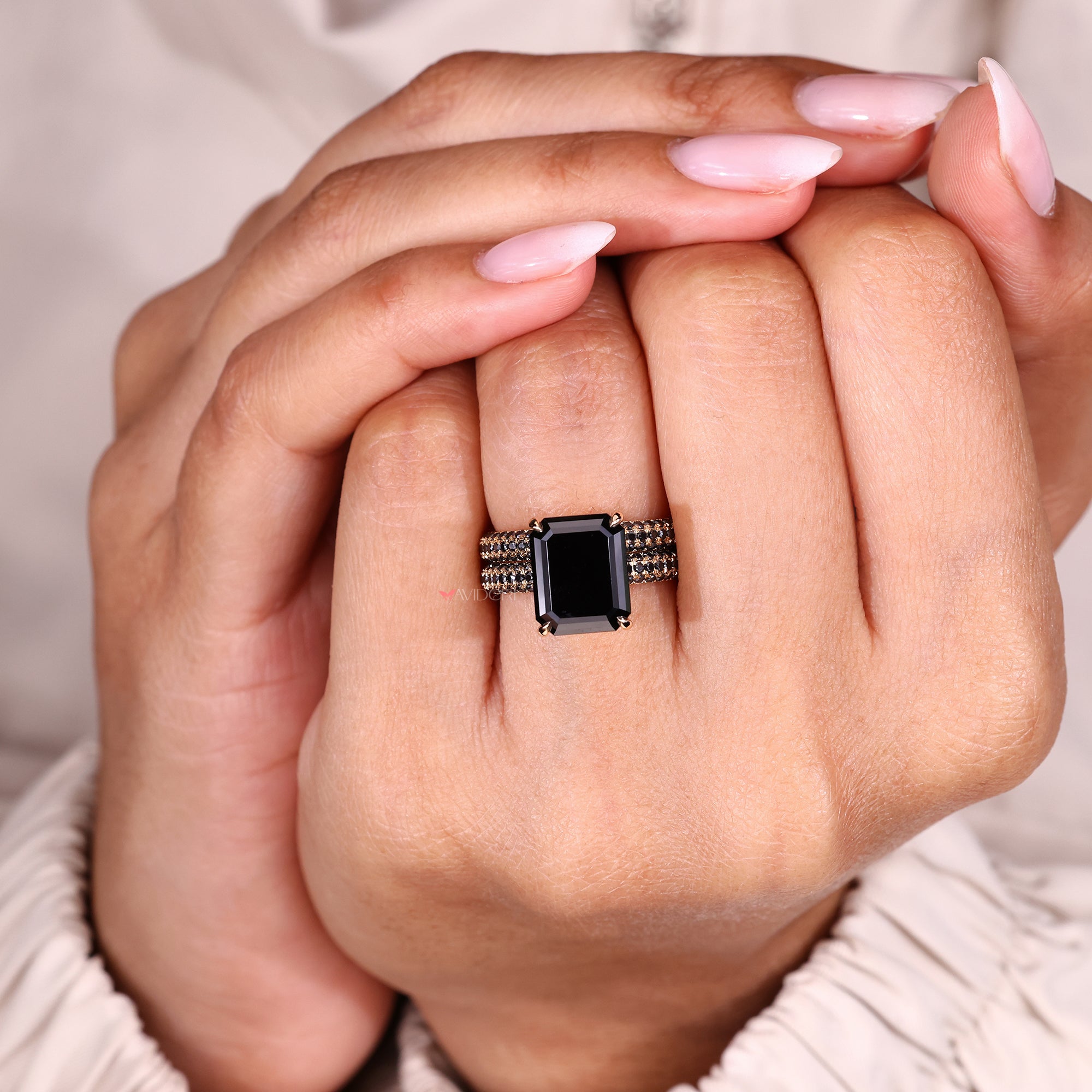 Milgrain engagement ring featuring an emerald cut moissanite center stone.
