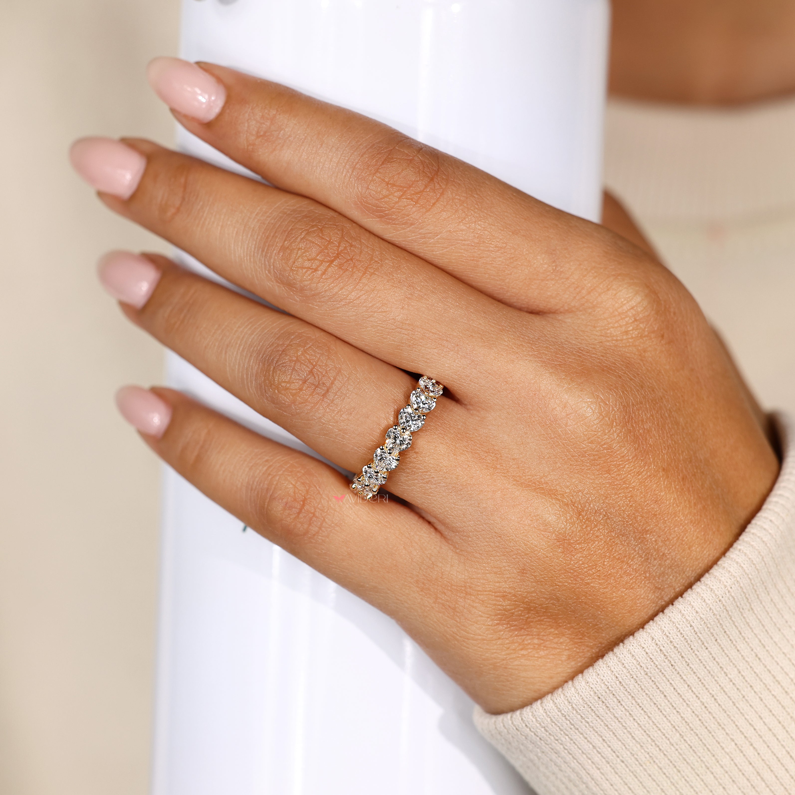 Heart diamond eternity band with shared prongs.
