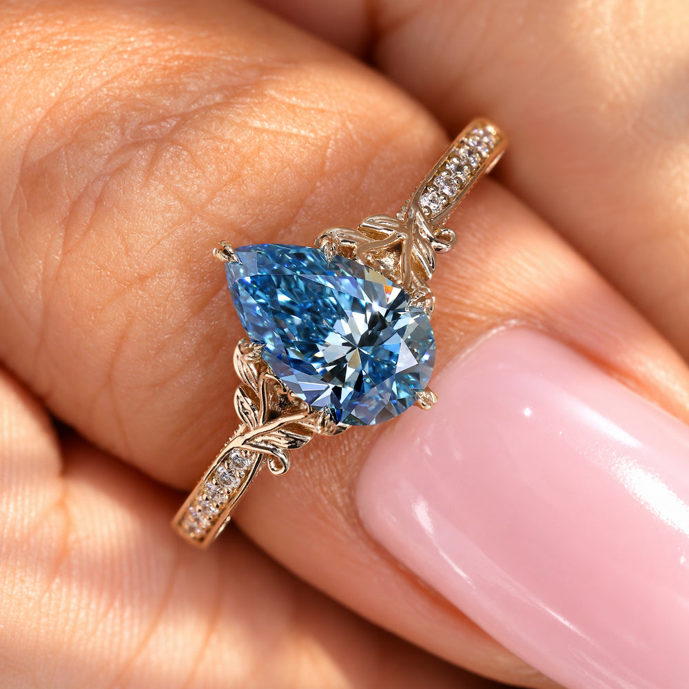 Art Deco pear diamond ring with filigree detailing.
