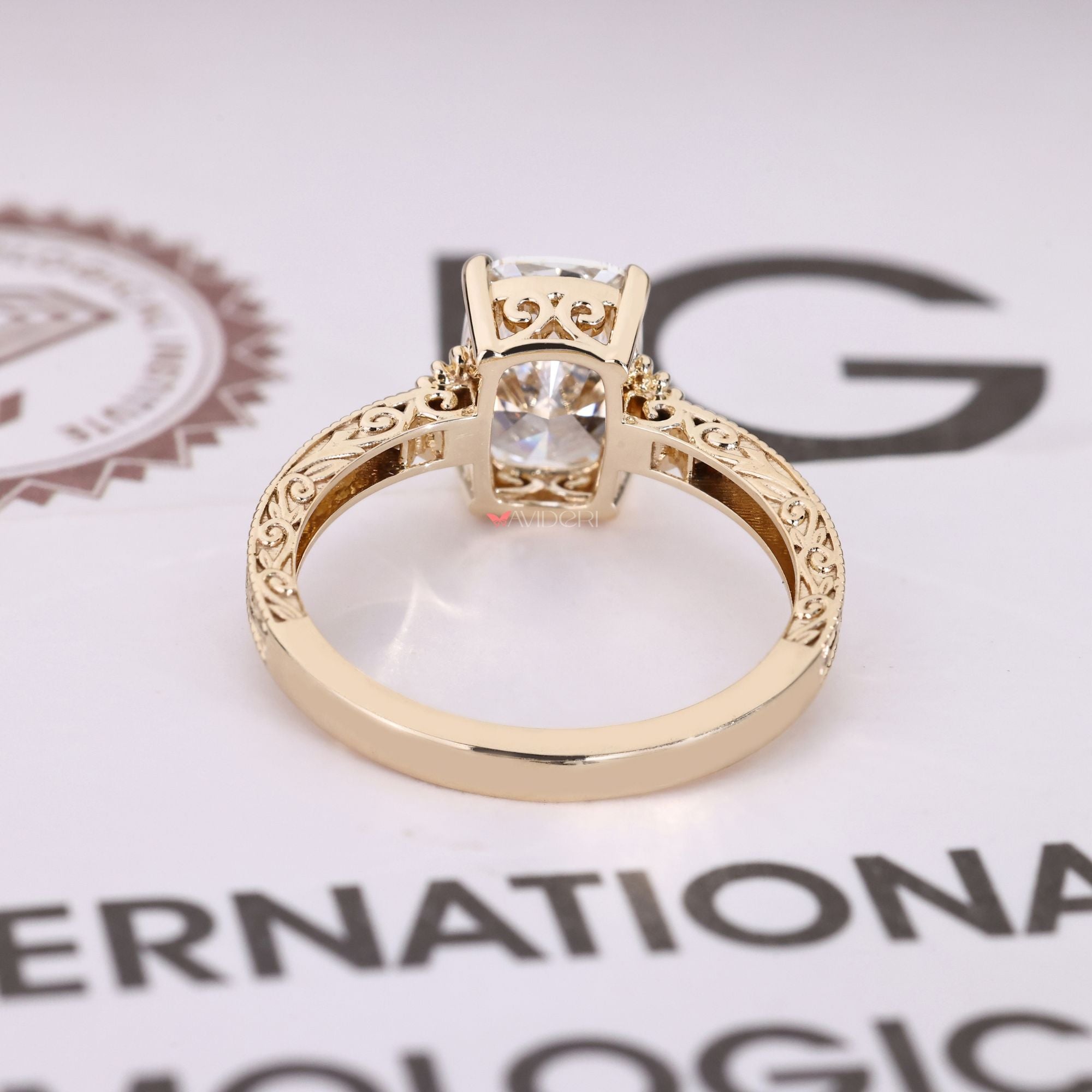 Solitaire cushion diamond ring with filigree detail.
