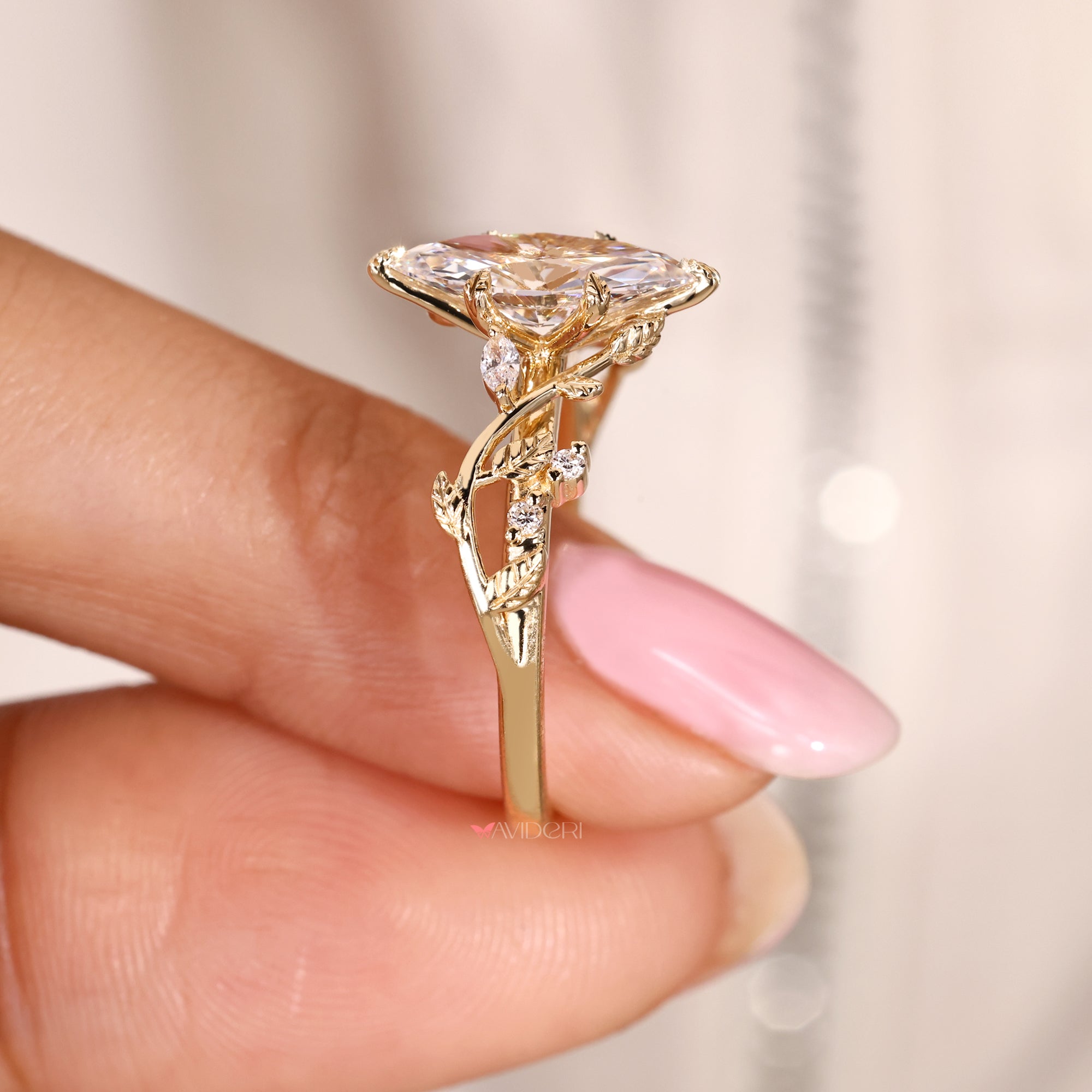 Nature inspired marquise diamond ring with leaf prongs.
