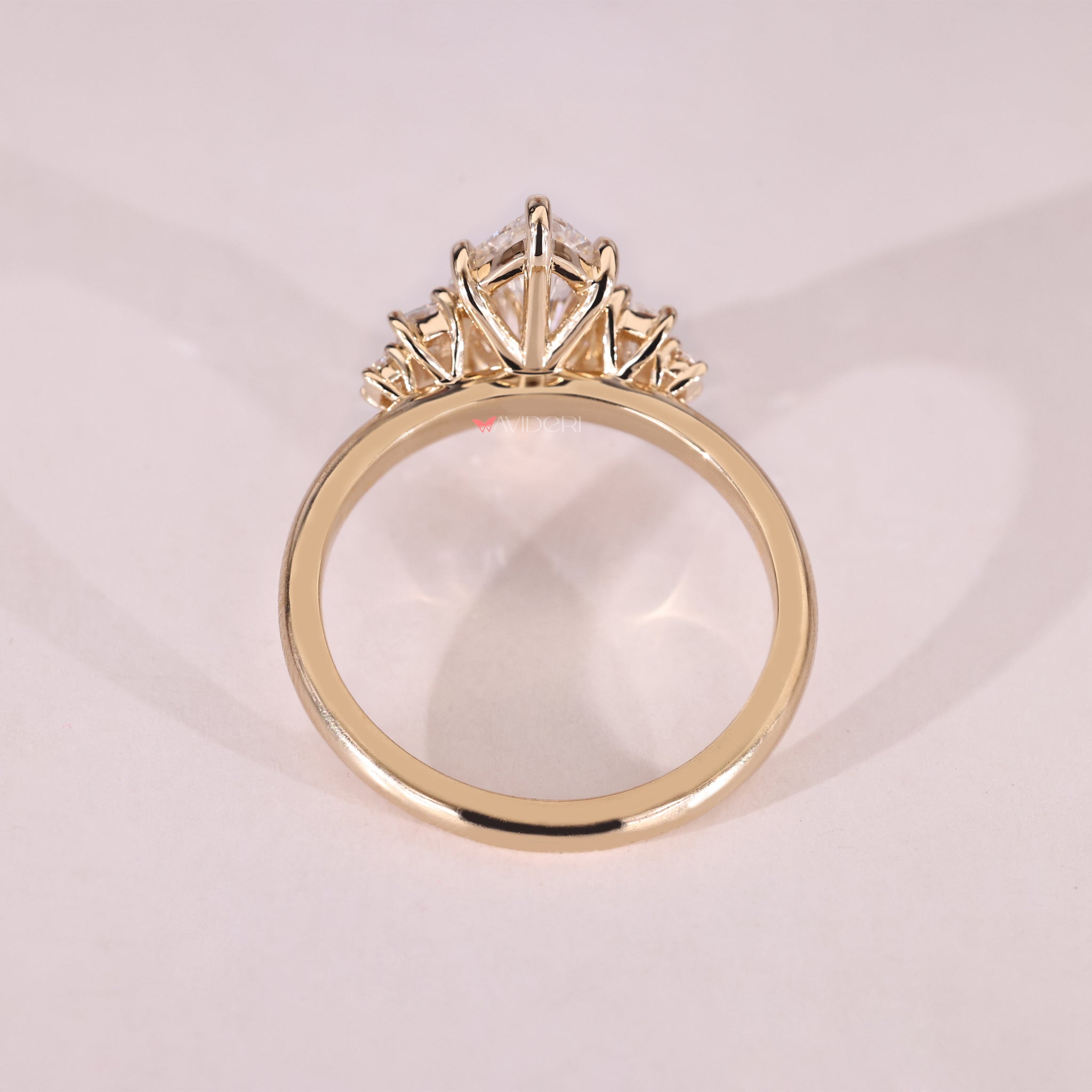 Five stone engagement ring featuring a marquise center and two baguette and round sides.
