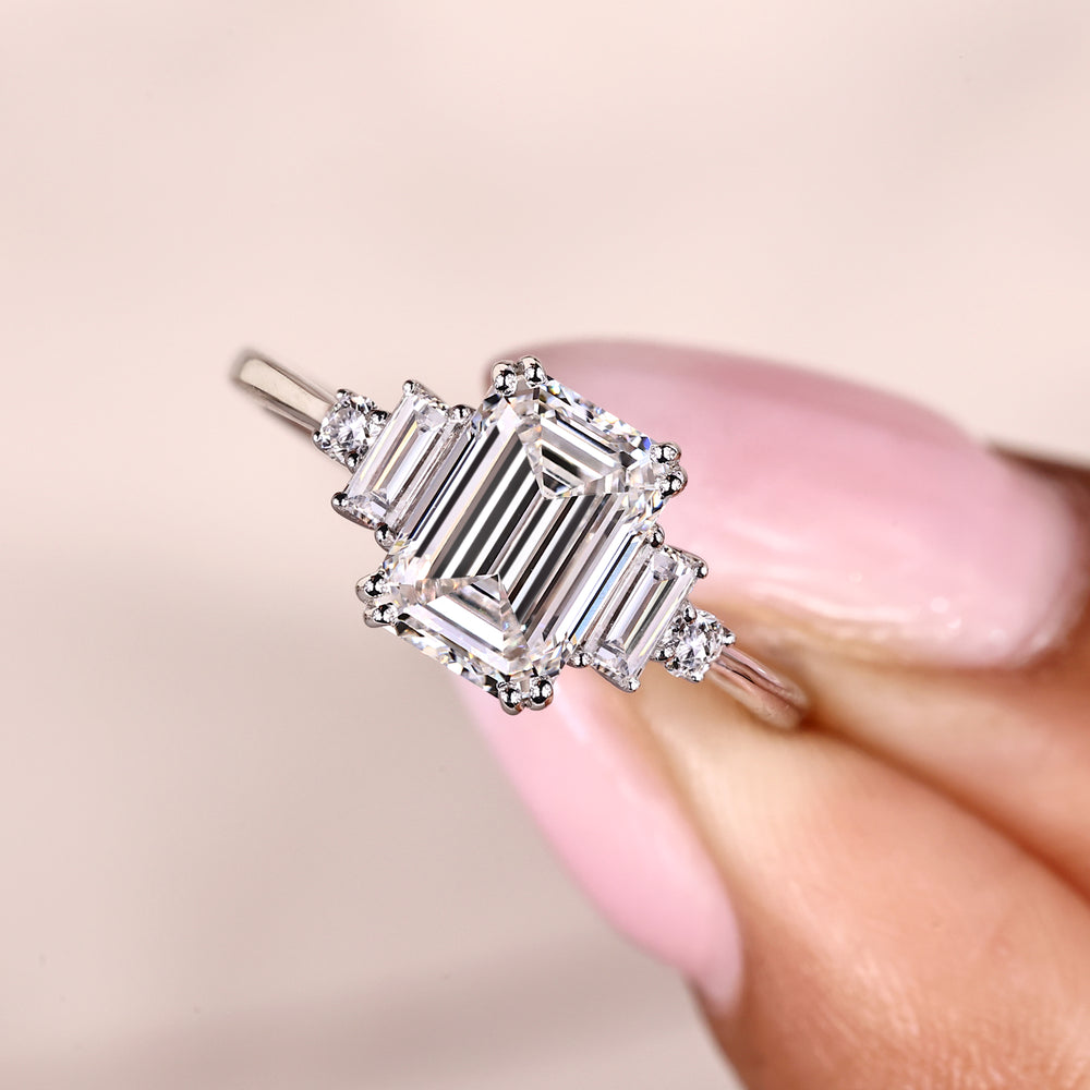 Double prong emerald cut five stone diamond ring.
