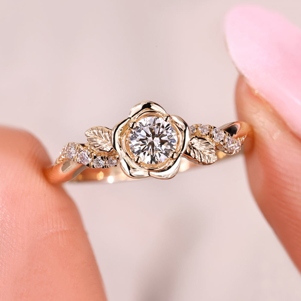 Vintage-inspired floral ring with a round diamond and leaf accents.