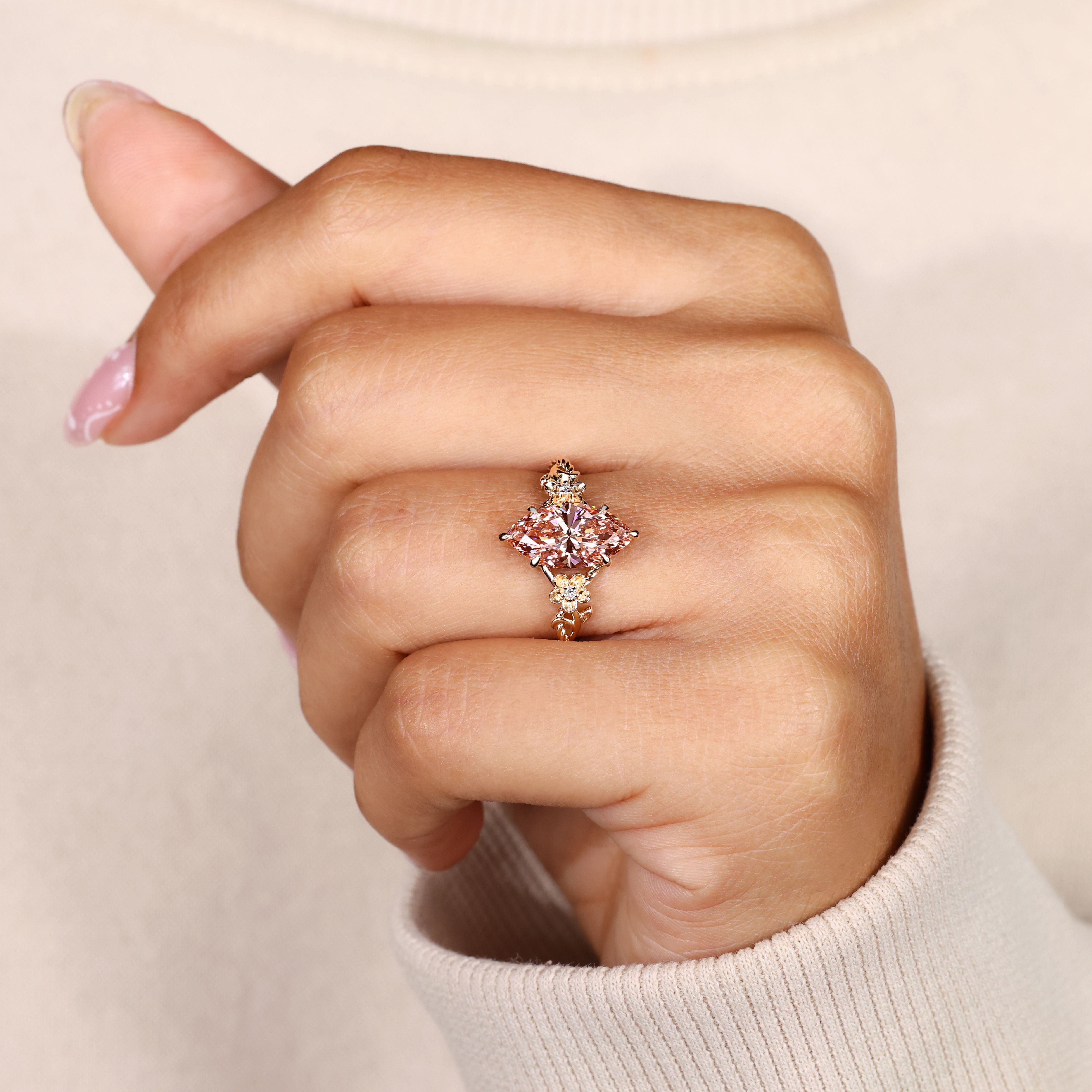 Marquise pink diamond ring with six claw prongs.
