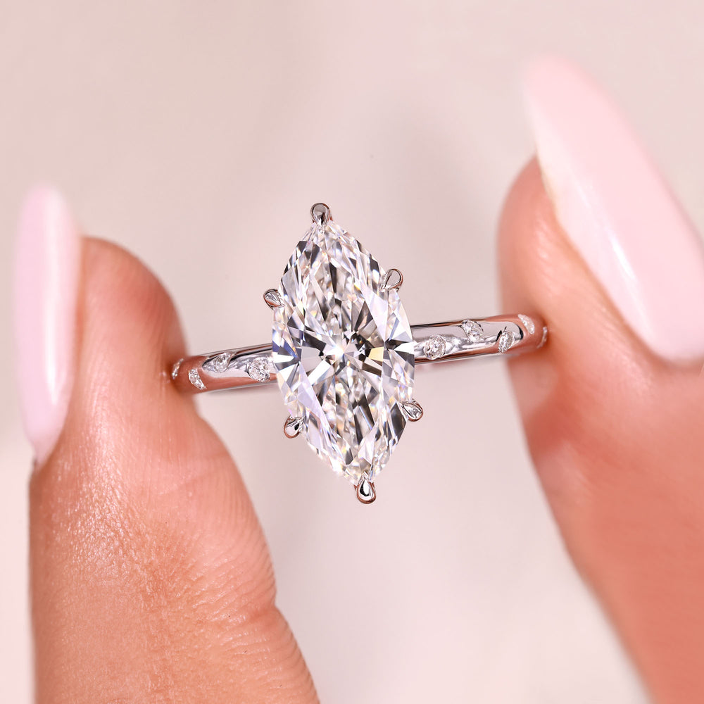 Marquise cut diamond ring with elegant pave band.
