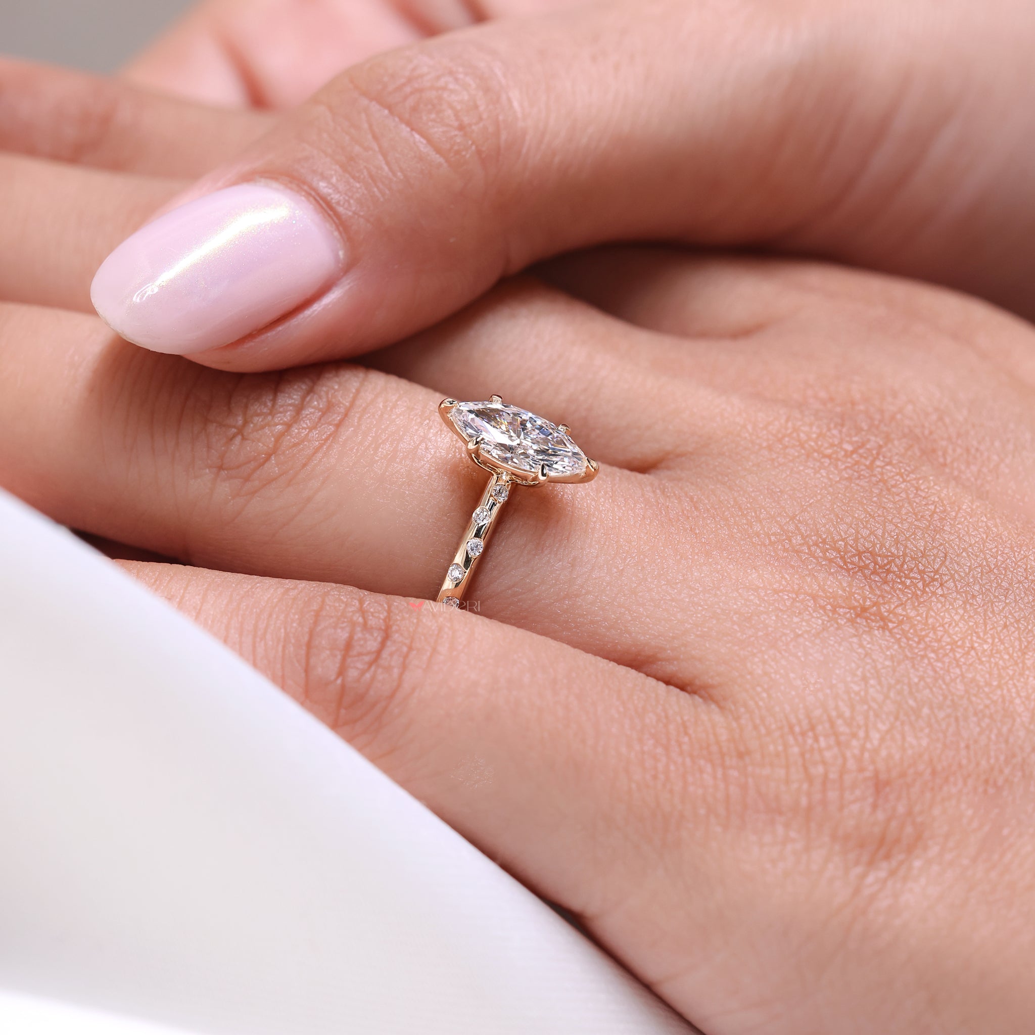 round diamond ring with marquise diamond accents and flush setting.