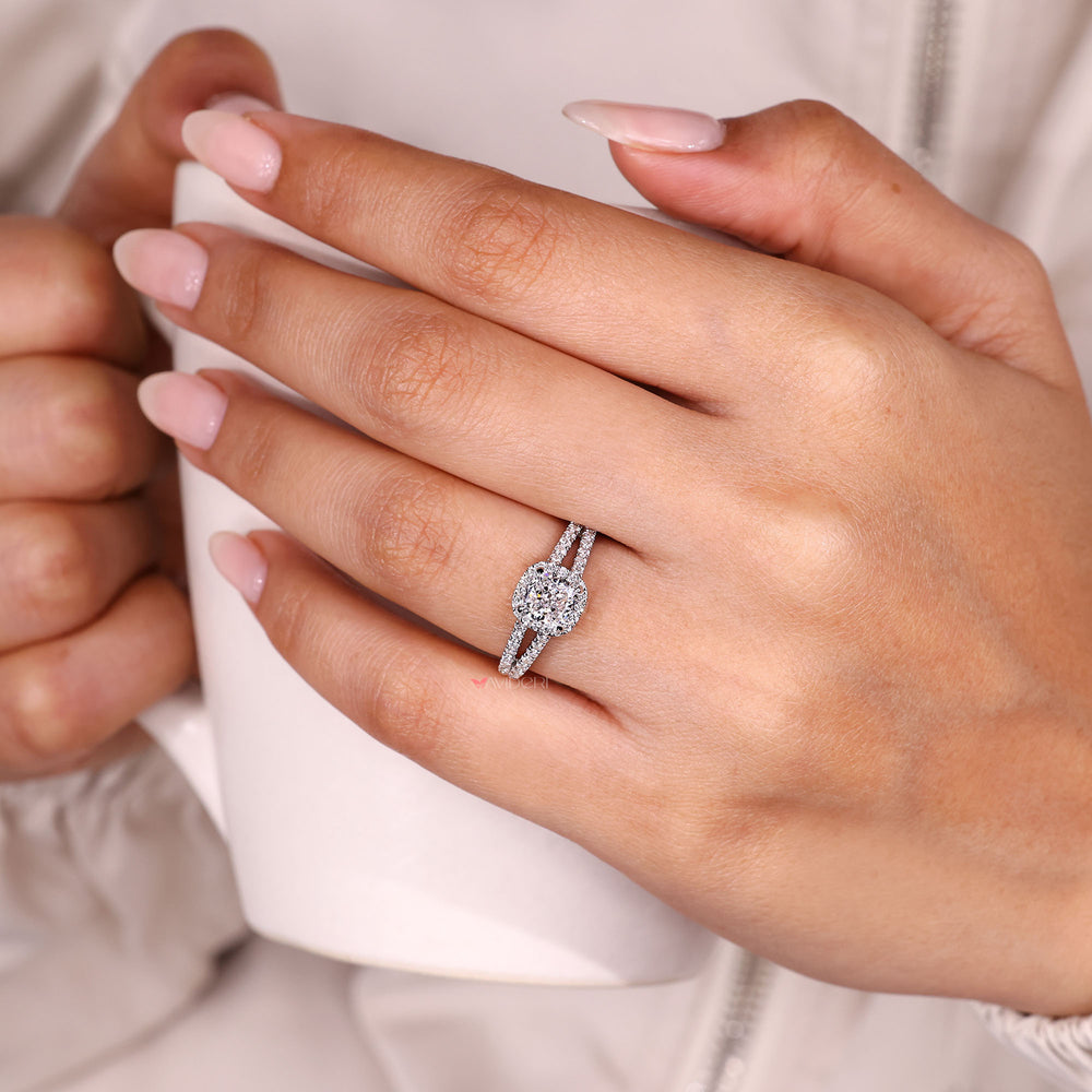 Cushion cut diamond halo ring with cathedral setting.
