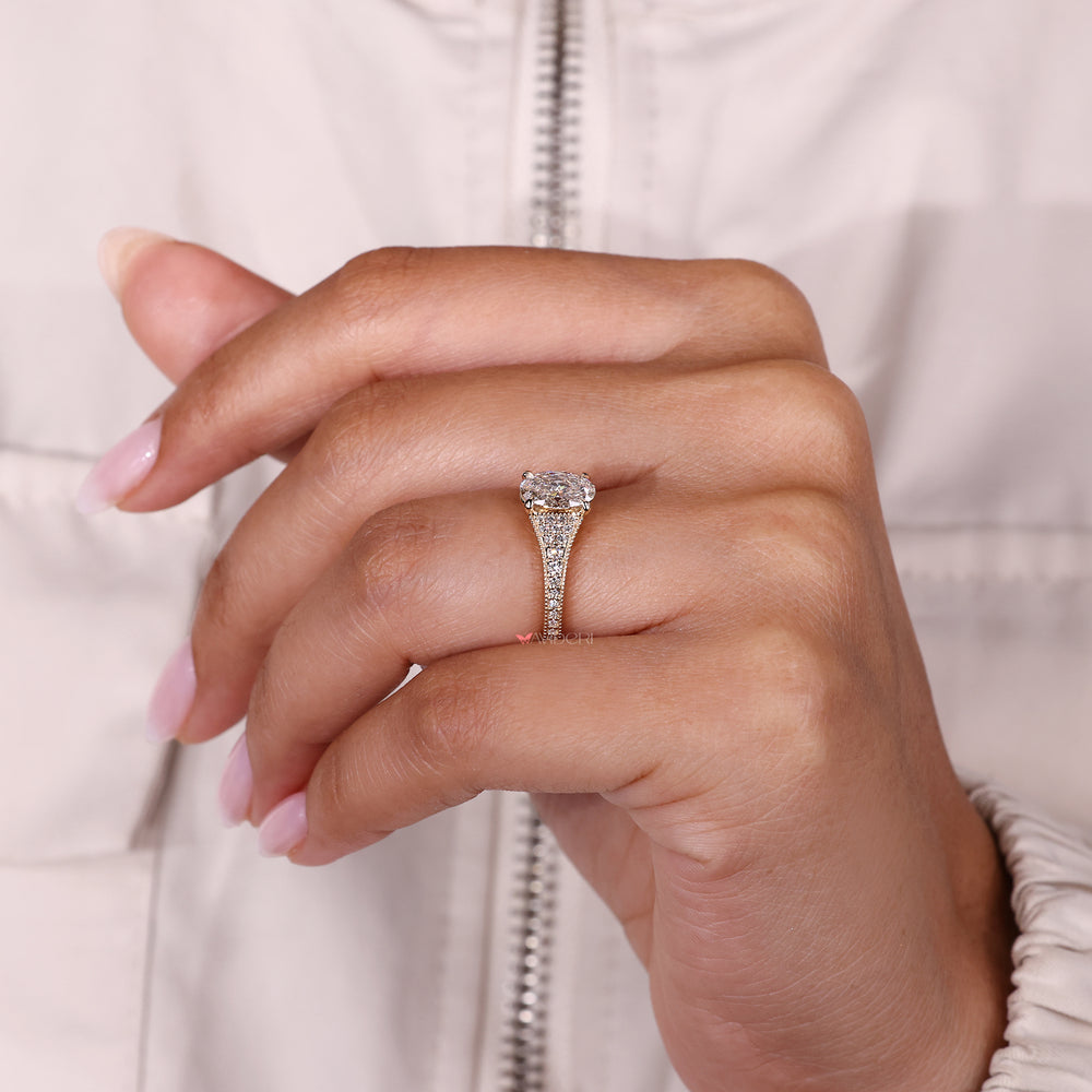 Oval cut ring with bridge accent design.
