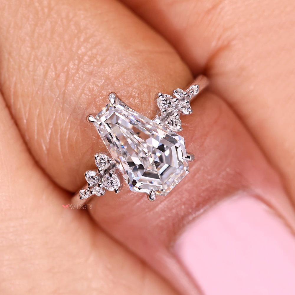 Coffin cut diamond ring with round accent stones.