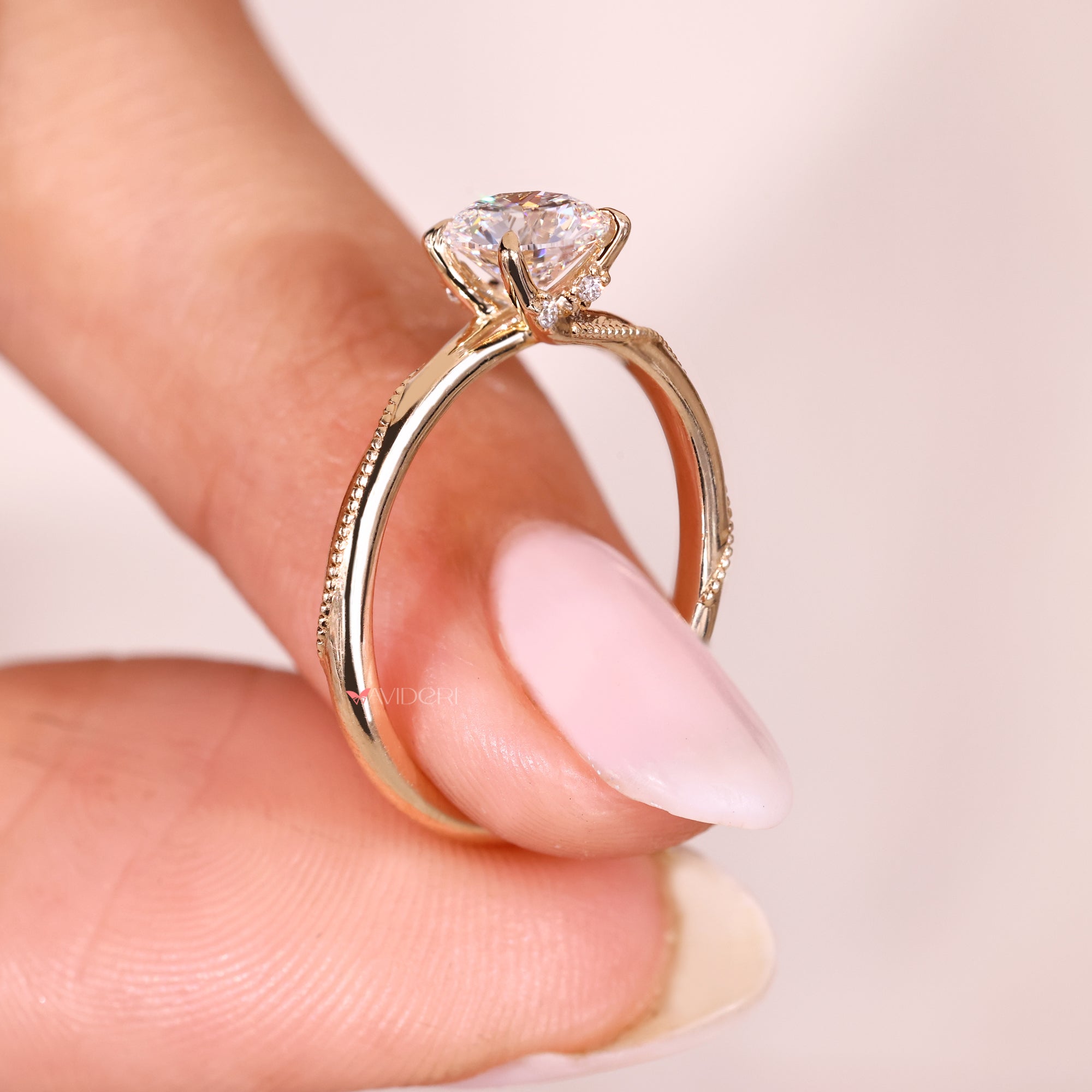 Lab grown round cut diamond ring with four claw prongs.
