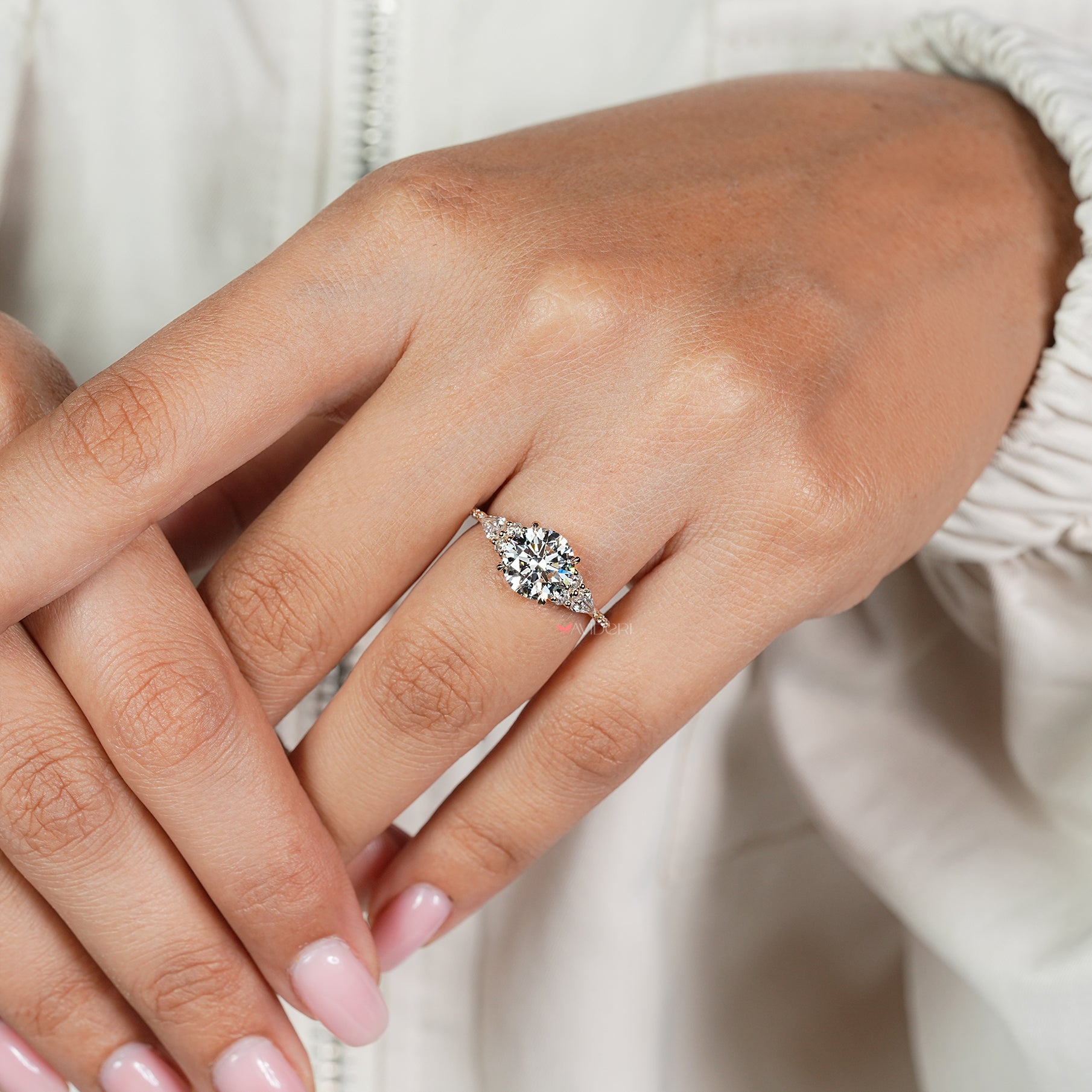 Four claw prong round diamond ring with pave setting
