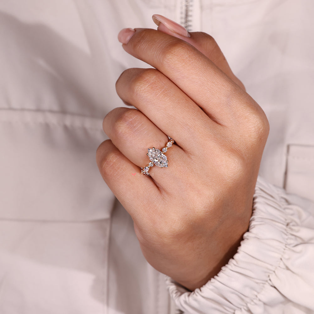 Dutch marquise diamond ring with round accents.
