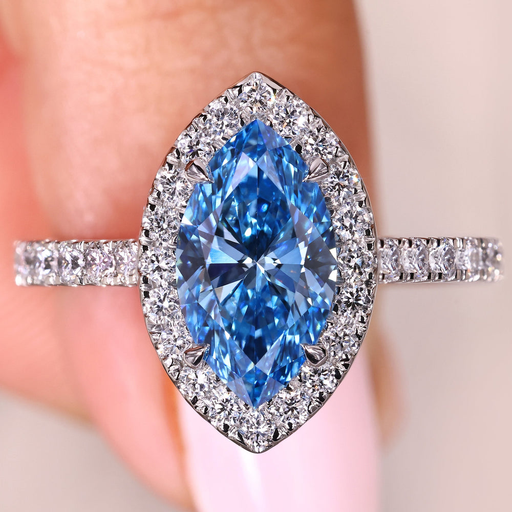 Marquise blue diamond ring with round halo and pave
