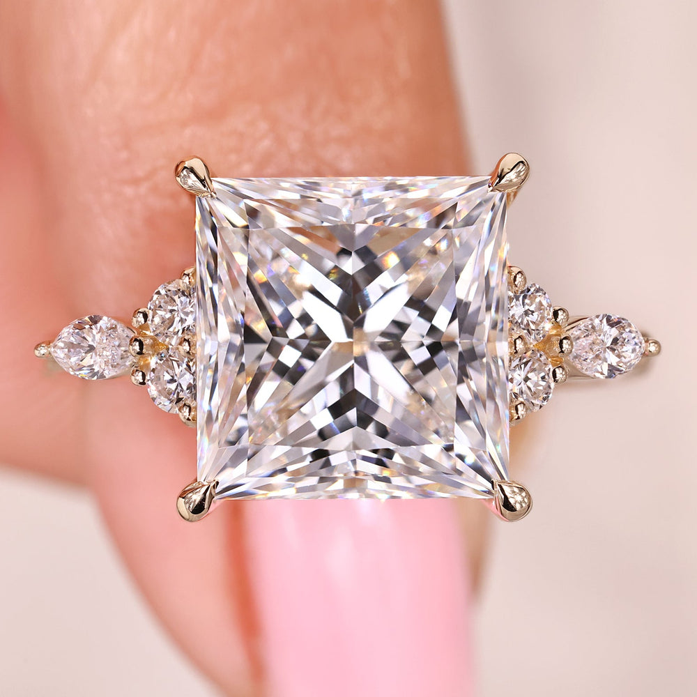 Princess cut diamond ring with marquise and round side stones.