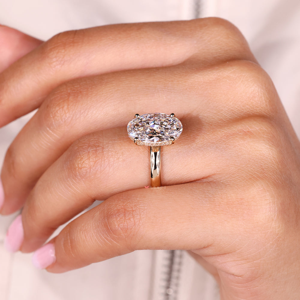 Oval cut diamond ring with subtle hidden halo design.
