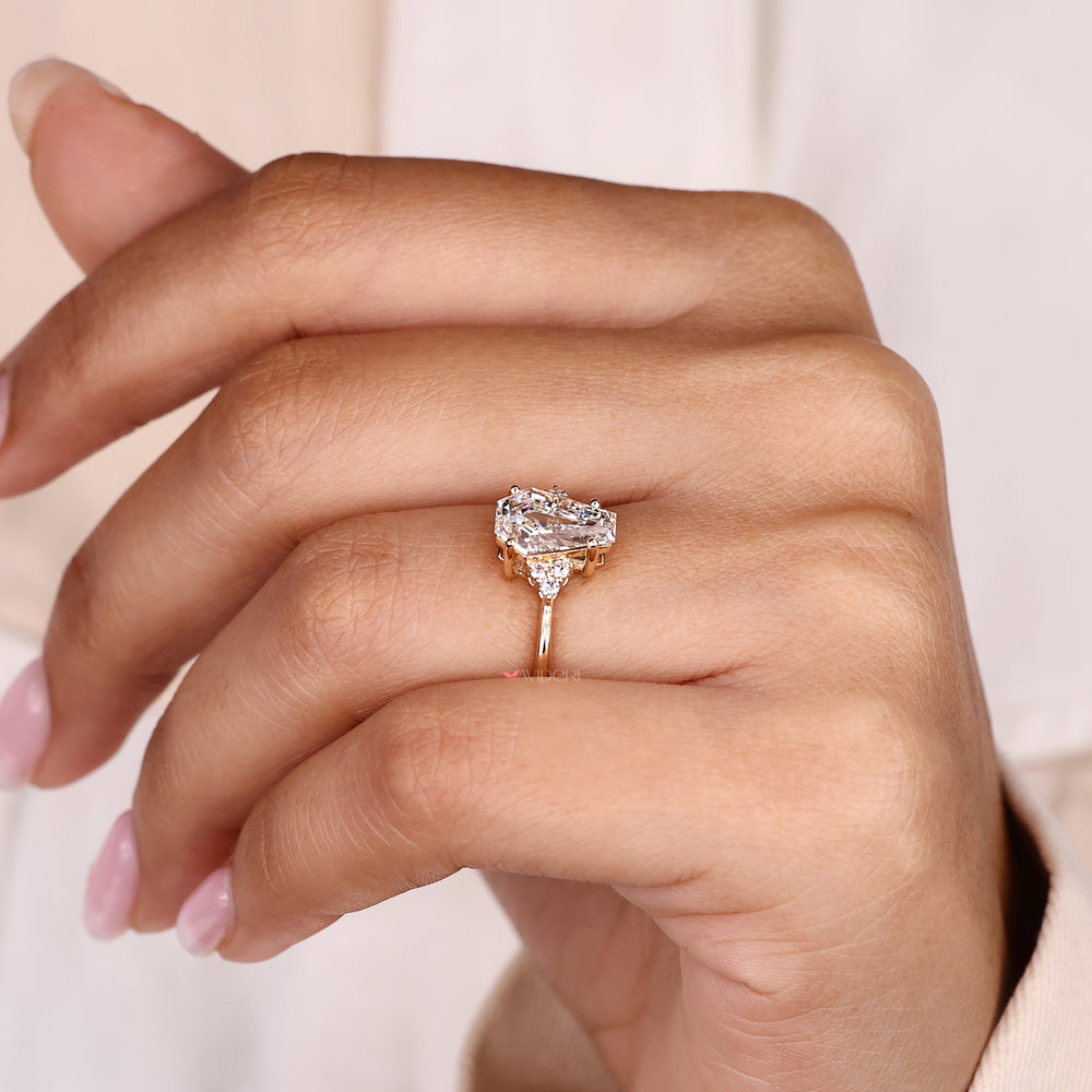 Four prong seven stone ring with coffin cut center diamond.