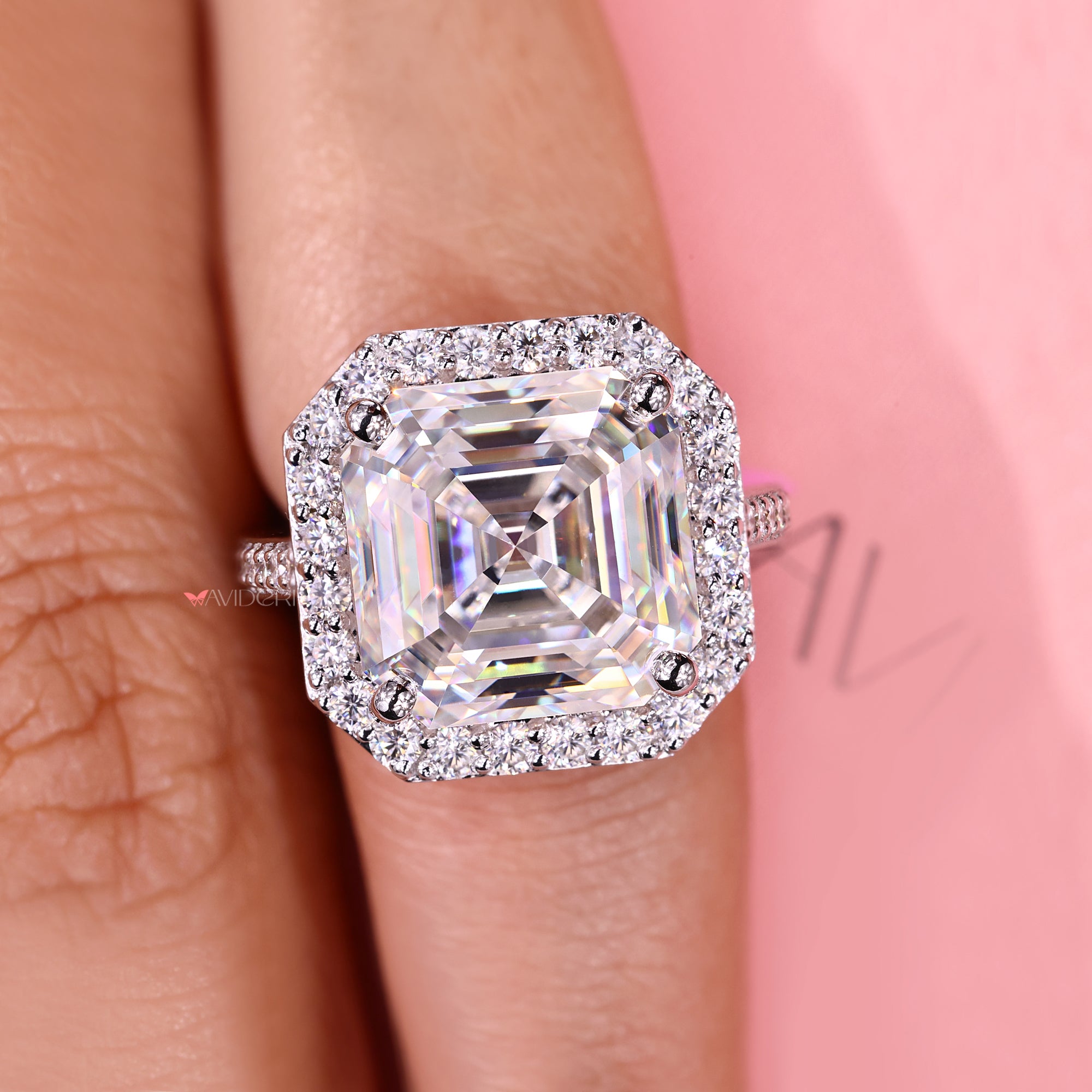 Asscher cut moissanite ring with round pave accents.