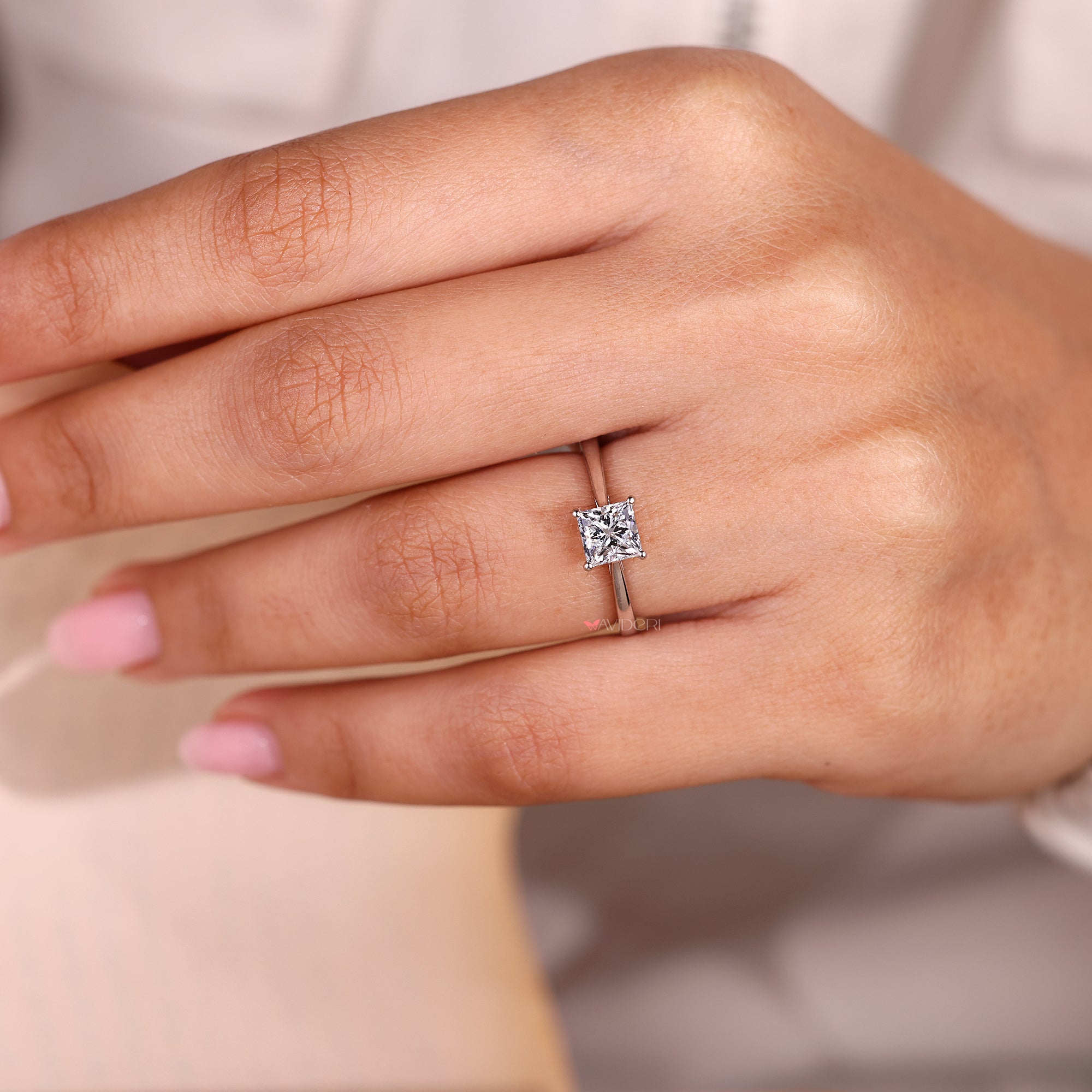 Princess cut ring with tapered shank and cathedral setting.
