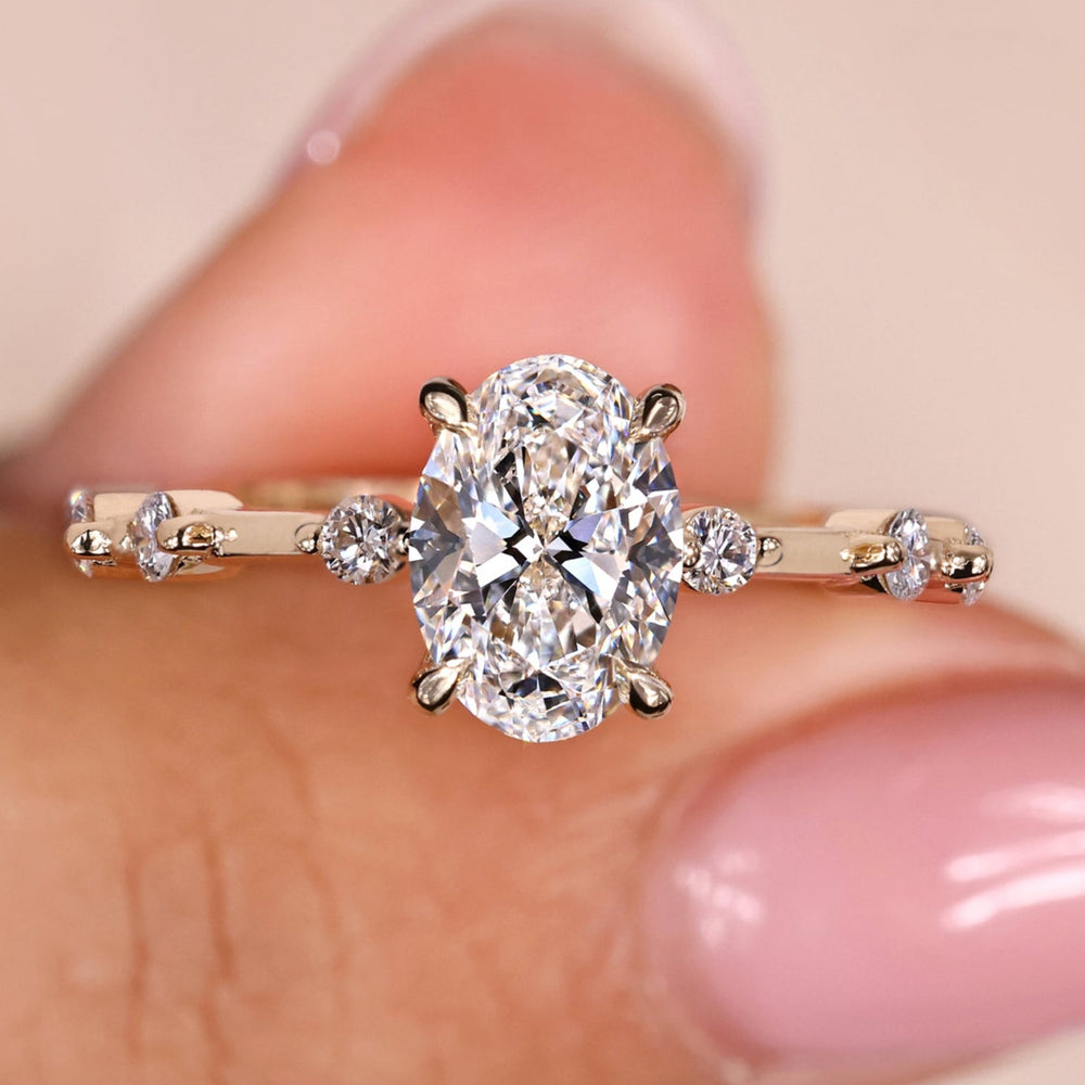 Oval diamond ring featuring a stunning oval cut engagement ring with a distance pave setting for timeless elegance.

