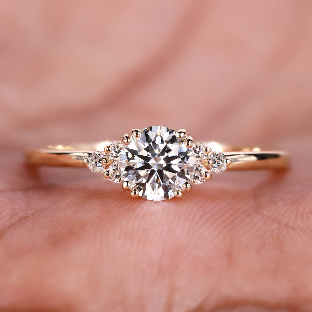An Image of a hand showing a round lab-grown diamond engagement ring.
