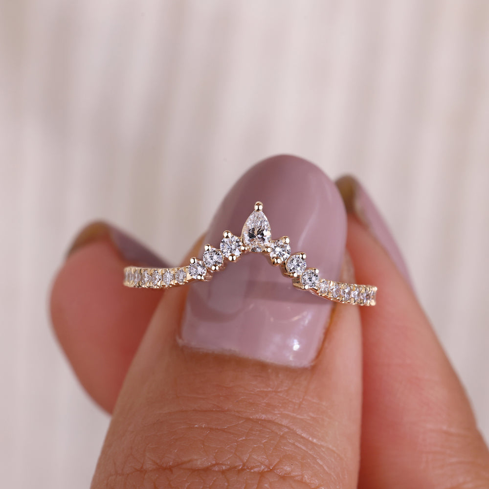  A stunning pear shaped diamond band with intricate detailing, showcasing its unique design and brilliance.

