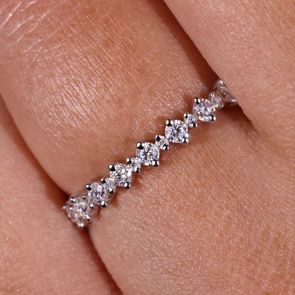 Round half eternity band featuring radiant round cut diamond for timeless elegance.

