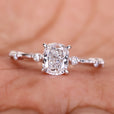 Elegant cushion cut engagement ring featuring a Lab Grown Diamond with a claw prong setting and Distance Pave Setting.
