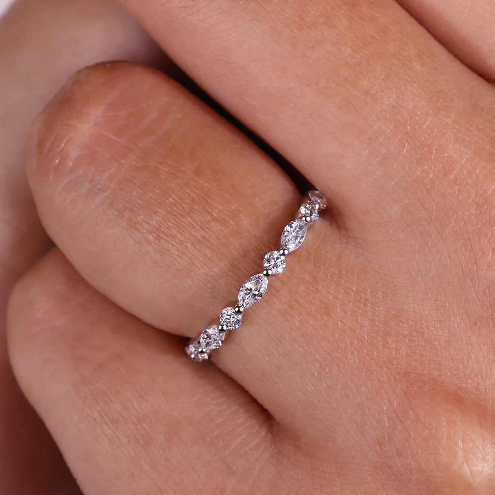 Elegant marquise and round wedding band designed with sparkling diamonds in a classic setting.
