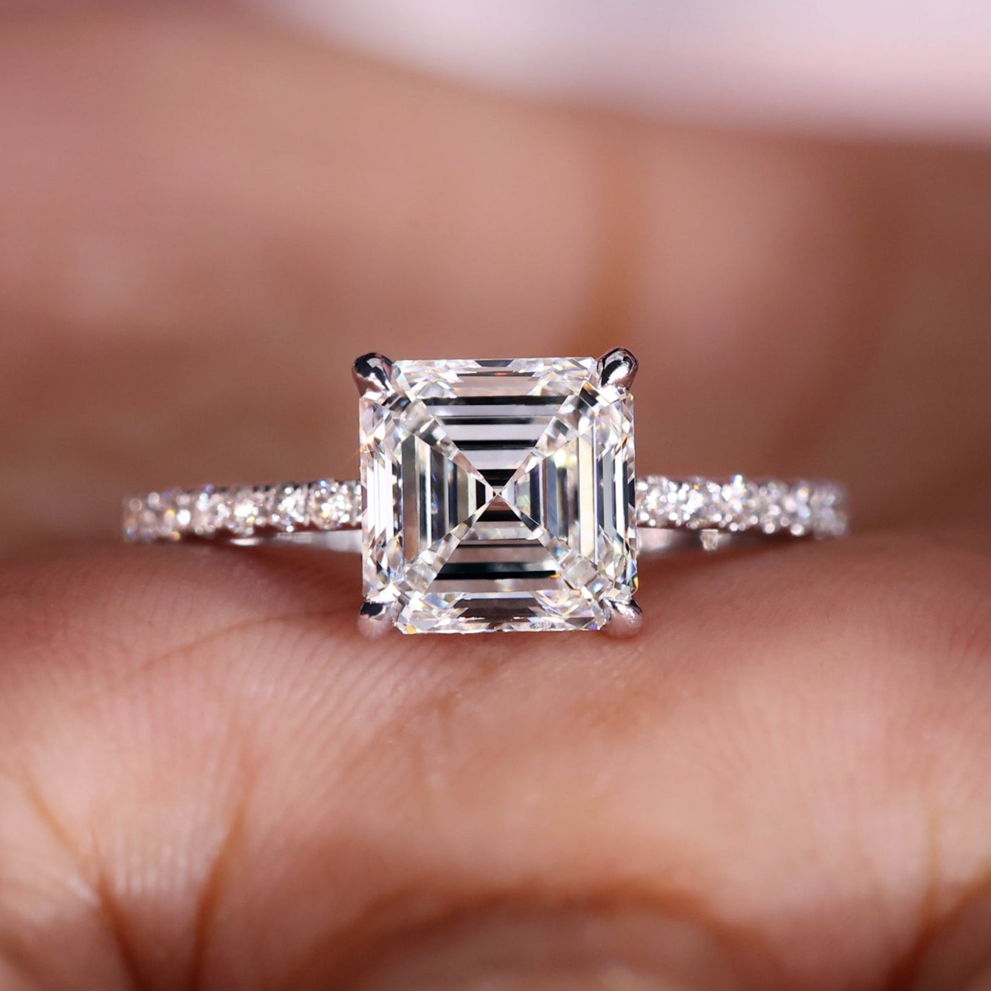 Asscher cut engagement ring with a pave setting and prong set diamonds for a timeless and elegant design.