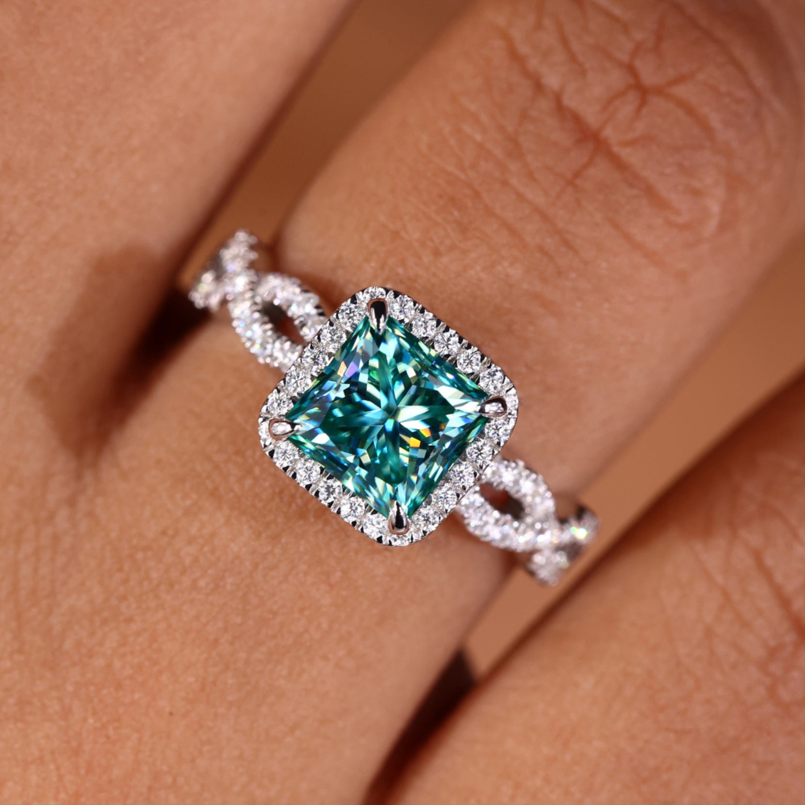 Princess cut halo engagement ring with a sparkling design.
