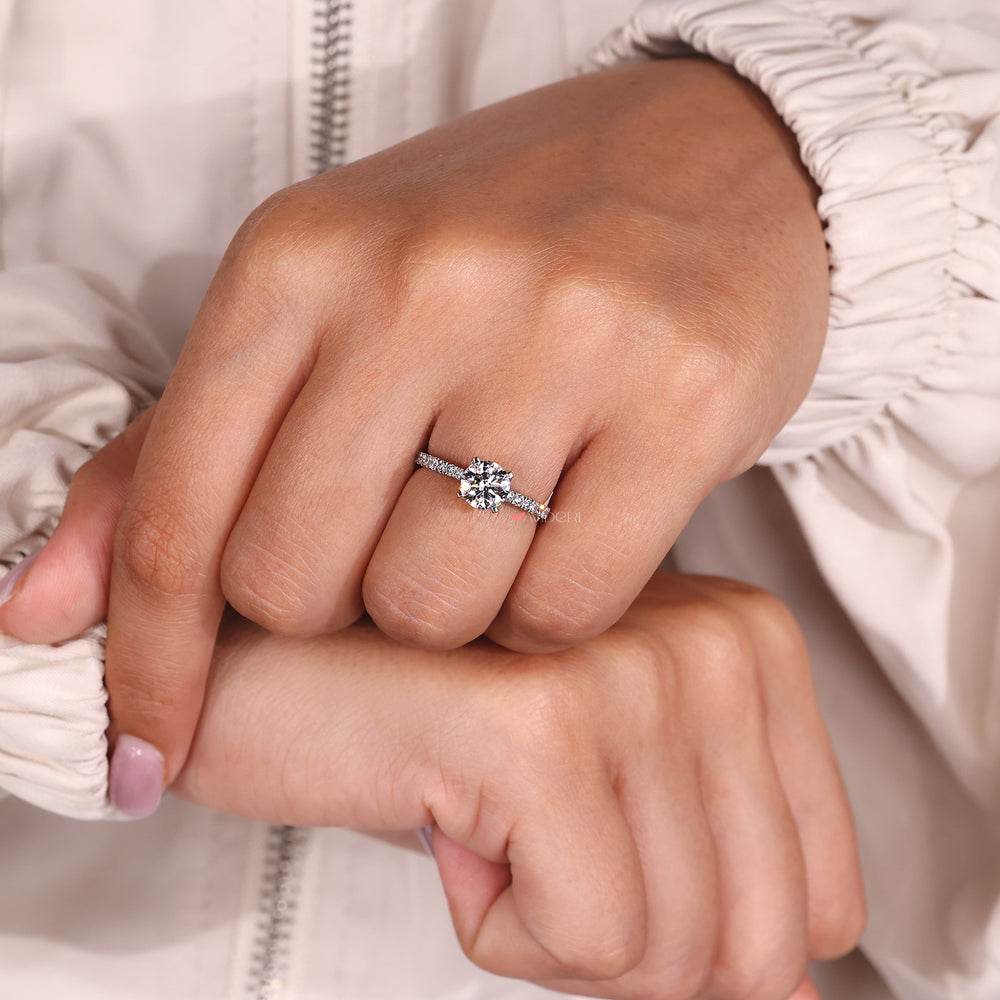 Pave setting engagement ring with a round diamond, offering a polished finish.
