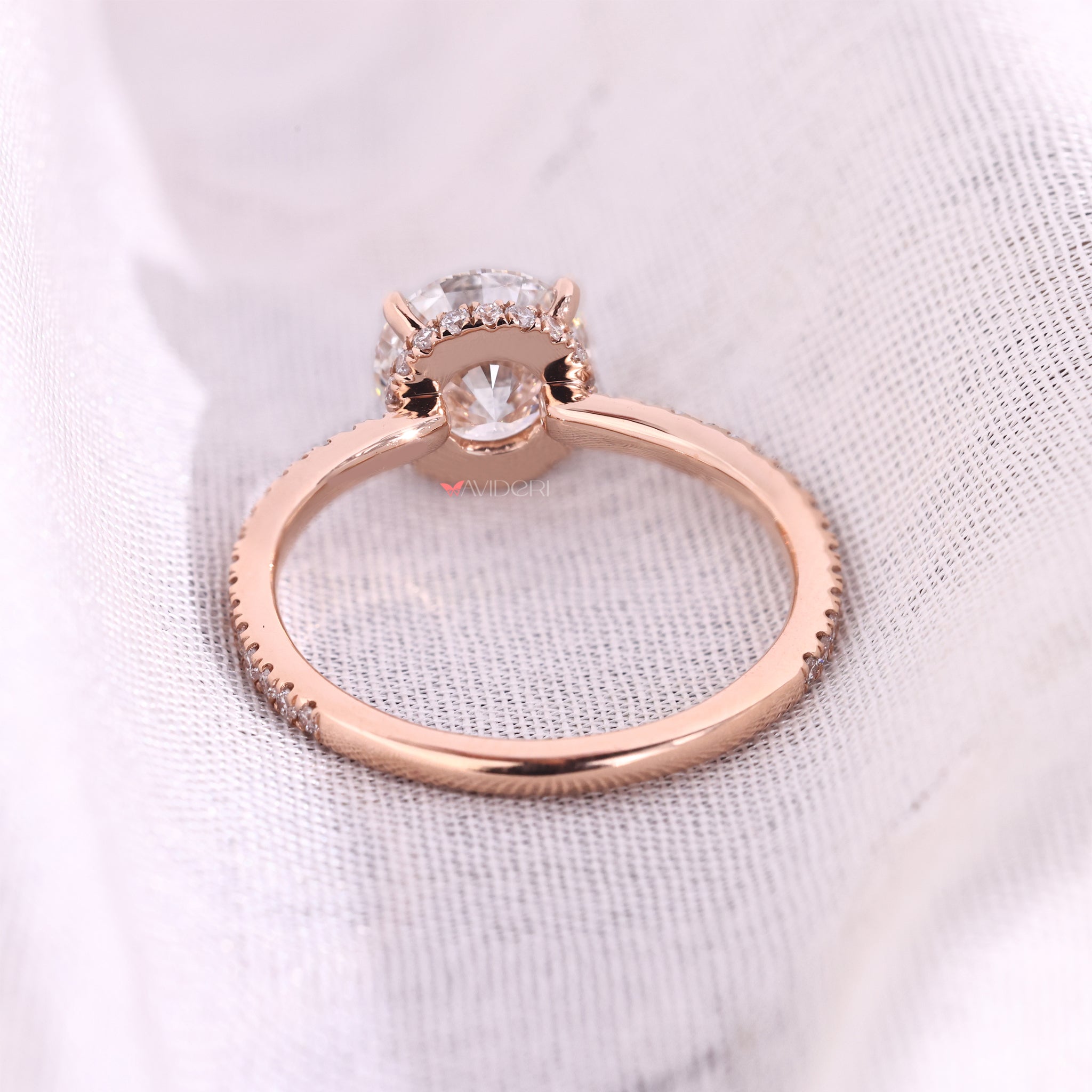 Hidden Halo engagement ring with round cut diamond and four claw prong setting from Avideri engagement ring.
