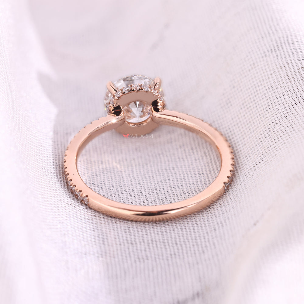 Hidden Halo engagement ring with round cut diamond and four claw prong setting from Avideri engagement ring.
