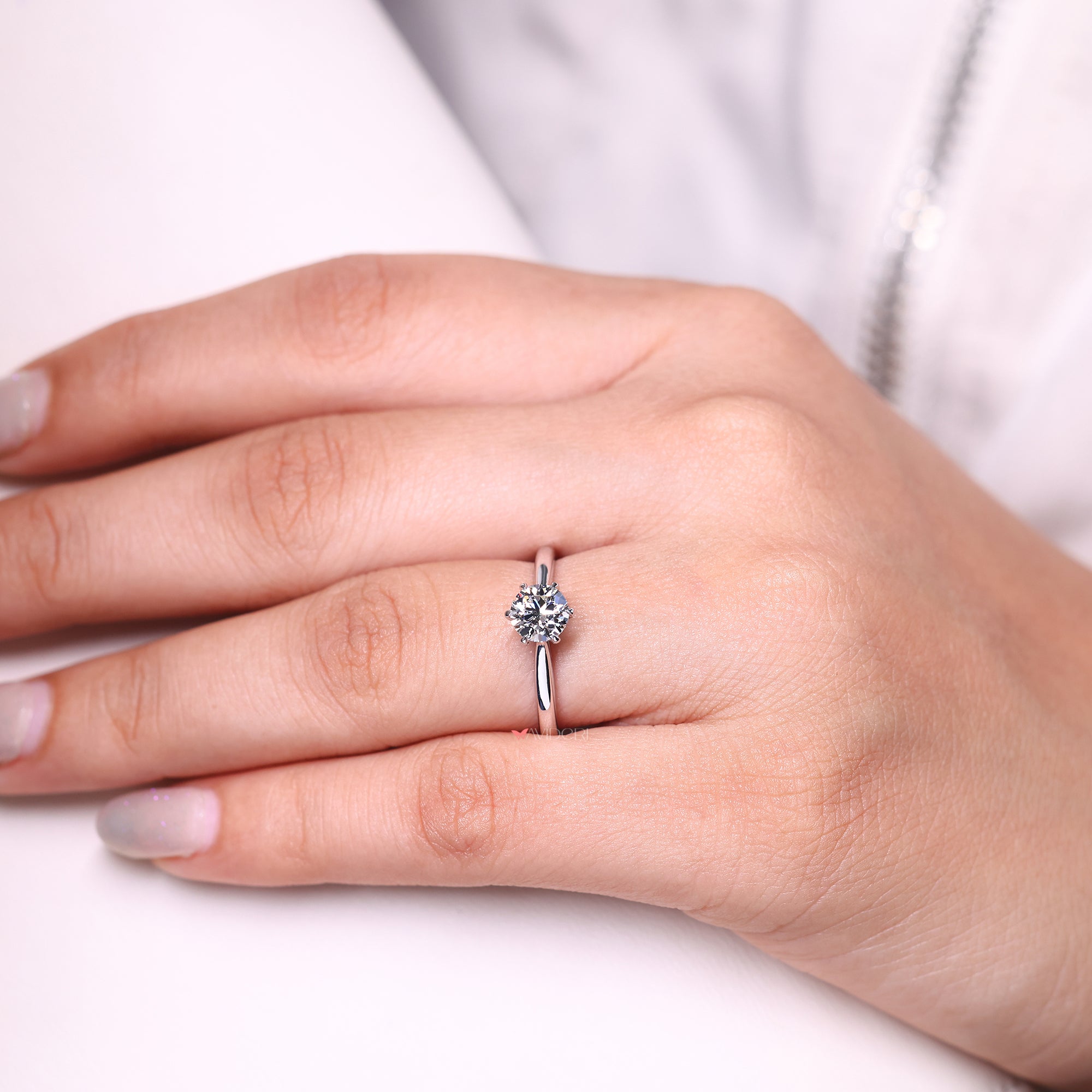 Custom solitaire engagement ring with tapered shank.