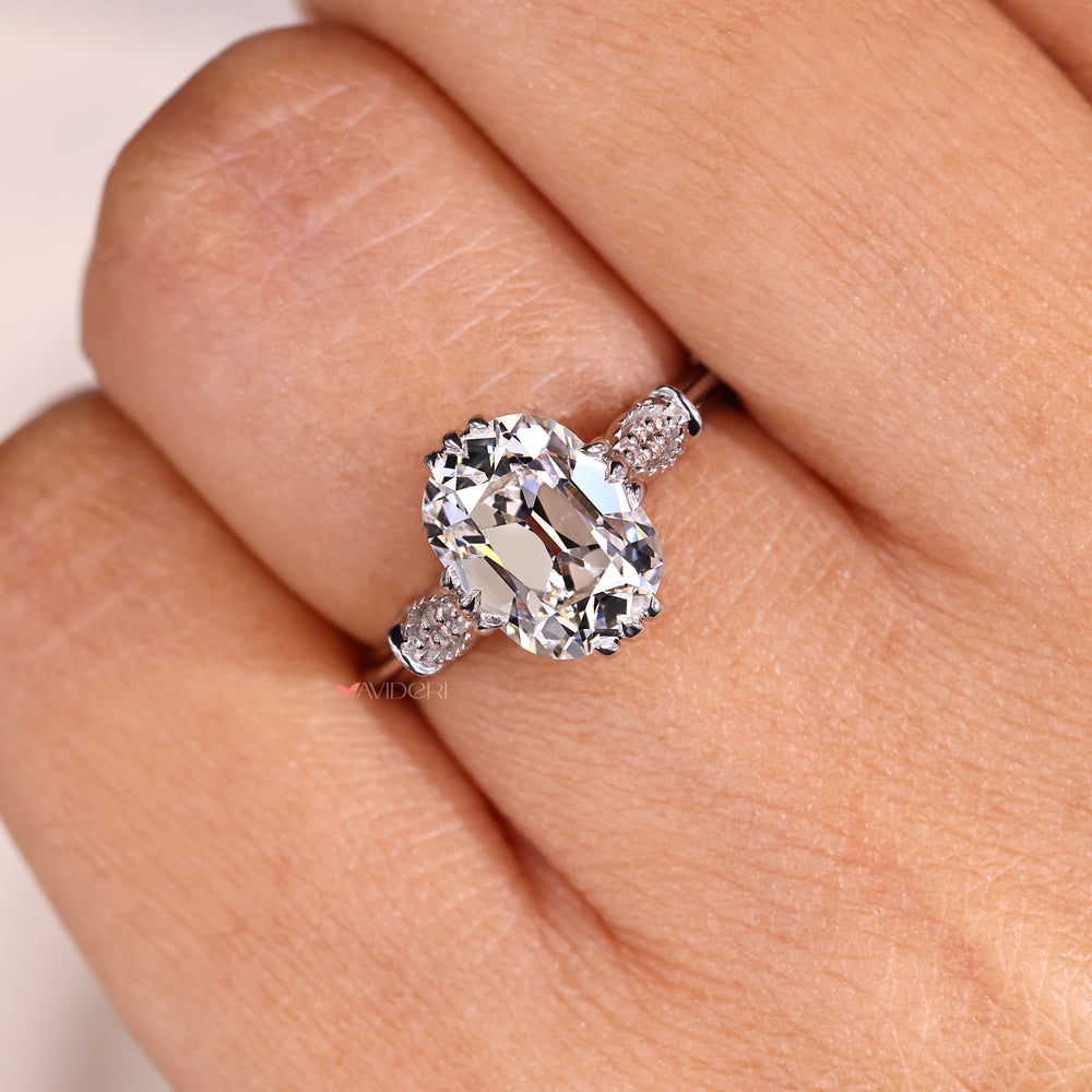 Cushion Old European Cut diamond ring with milgrain side setting in white gold.