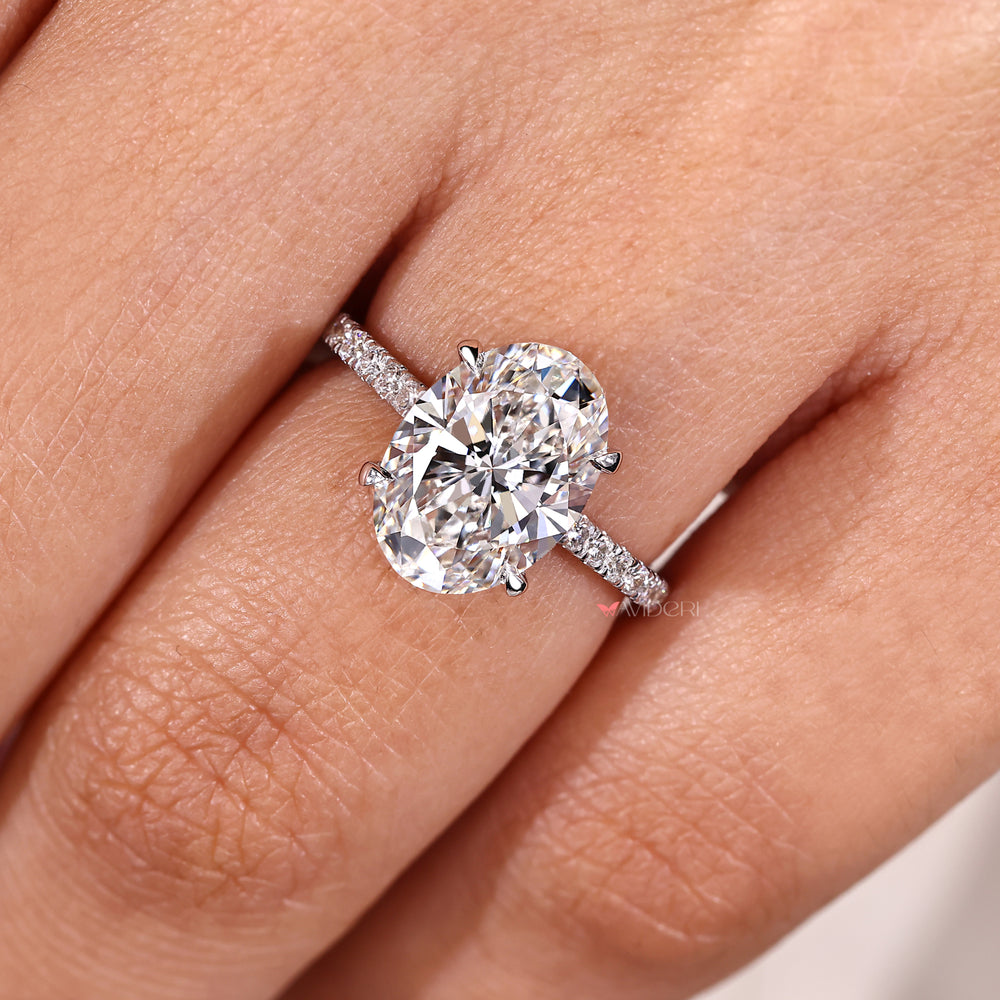 Oval engagement ring with four claw prongs handmade.