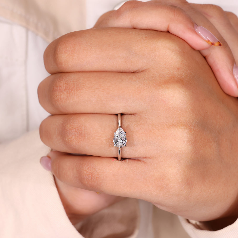 Pear Engagement Ring featuring a solitaire diamond in a cathedral setting.
