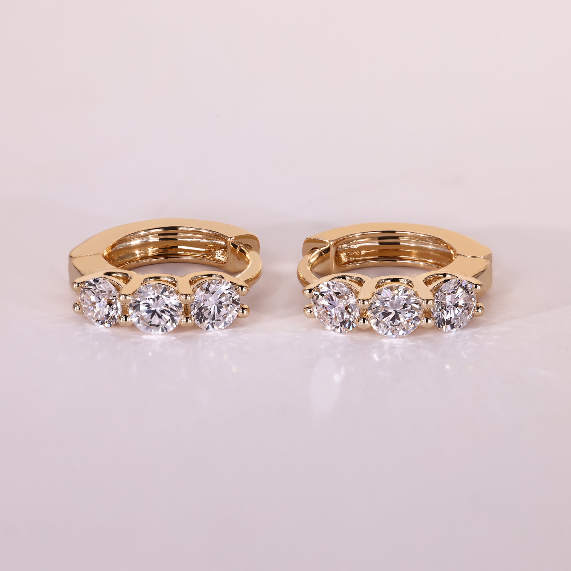 Round cut diamond earrings in hoop earrings design.