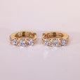 Round cut diamond earrings in hoop earrings design.
