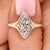 Marquise cut engagement ring with bezel type prong setting.
